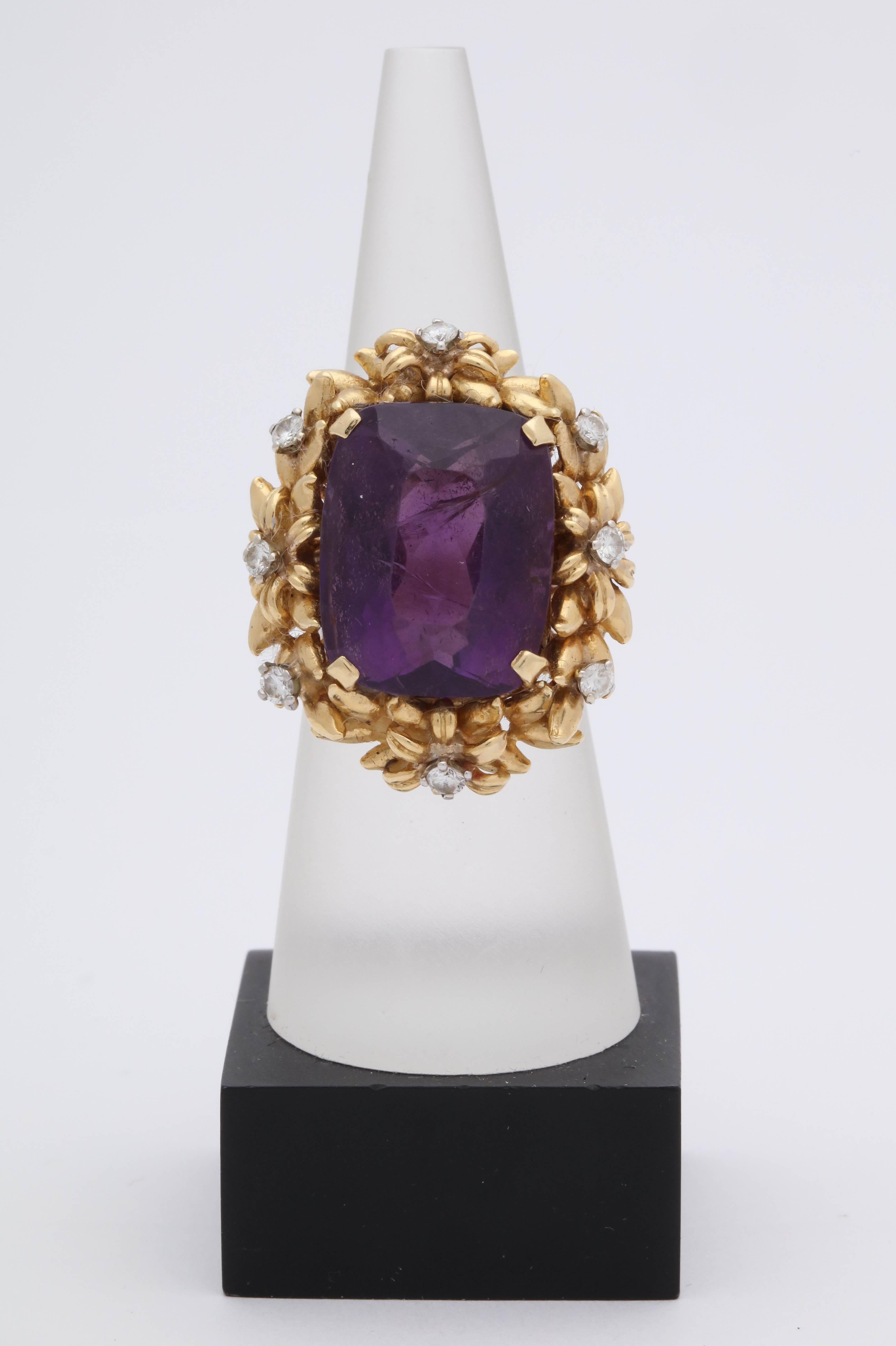 One Ladies 18kt Yellow Gold Cocktail Ring Featuring A 20 Carat Emerald Cut Beautiful Color Amethyst . Further Designed With Eight Full Cut Diamonds Weighing Approximately .70 Cts Total Weight. Ring Has Beautiful Floral Design Craftmanship And