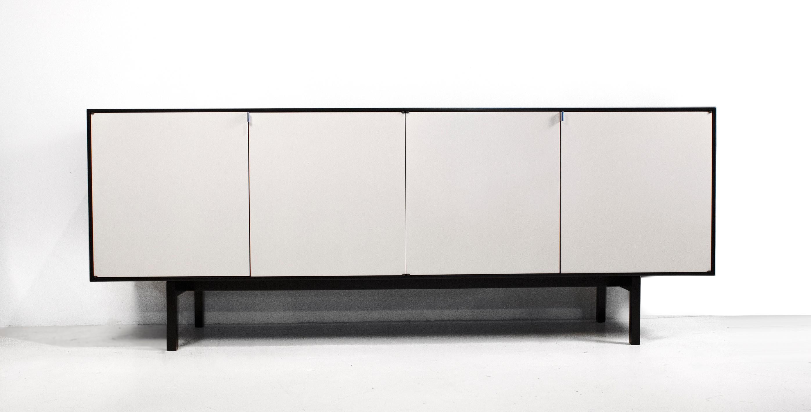 Early Florence Knoll model 541 credenza with black case, antique white doors and maple interior. All original specs in exceptional condition. This is considered by many collectors to be the best credenza that Florence ever designed. It is very