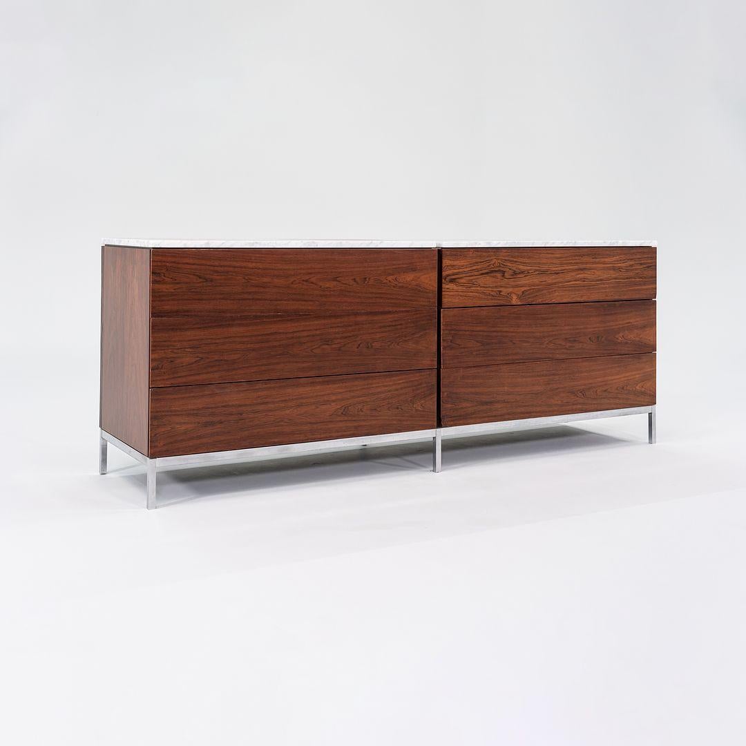 This is a Double Dresser, designed by Florence Knoll for Knoll International in 1958. This example dates to the late 1950s and features a rich Brazilian Rosewood Veneer. The wooden case sports six wide drawers and sits atop a chromed-steel base with