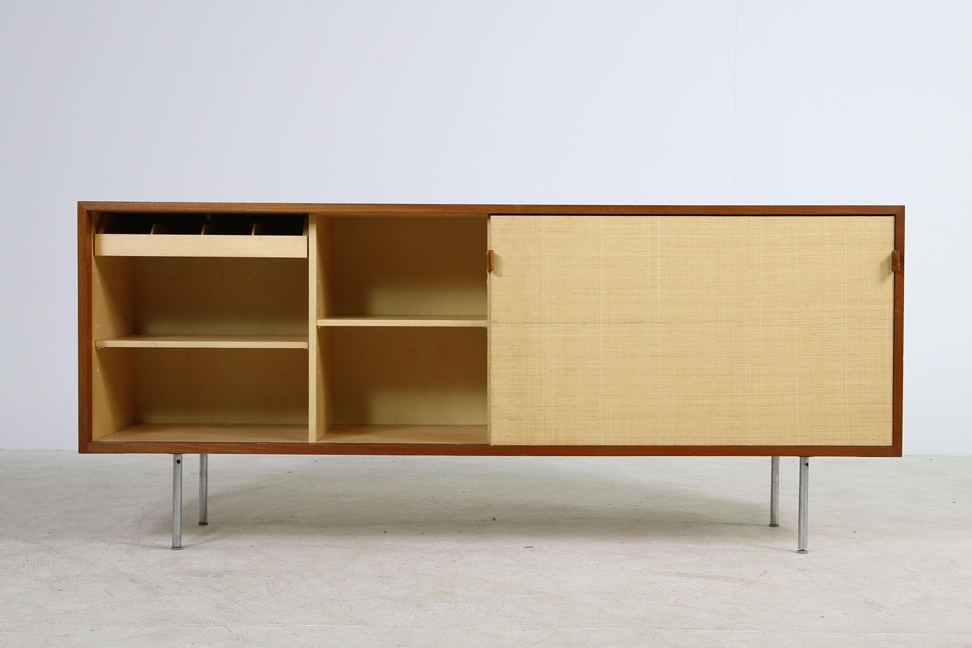 Beautiful and super rare vintage Florence Knoll Mod. 116 seagrass sideboard, made by Knoll International, made in Germany about 1949 in Teak wood and seagrass sliding doors - a very rare piece.

Also inside very clean, maple wood, shelves inside