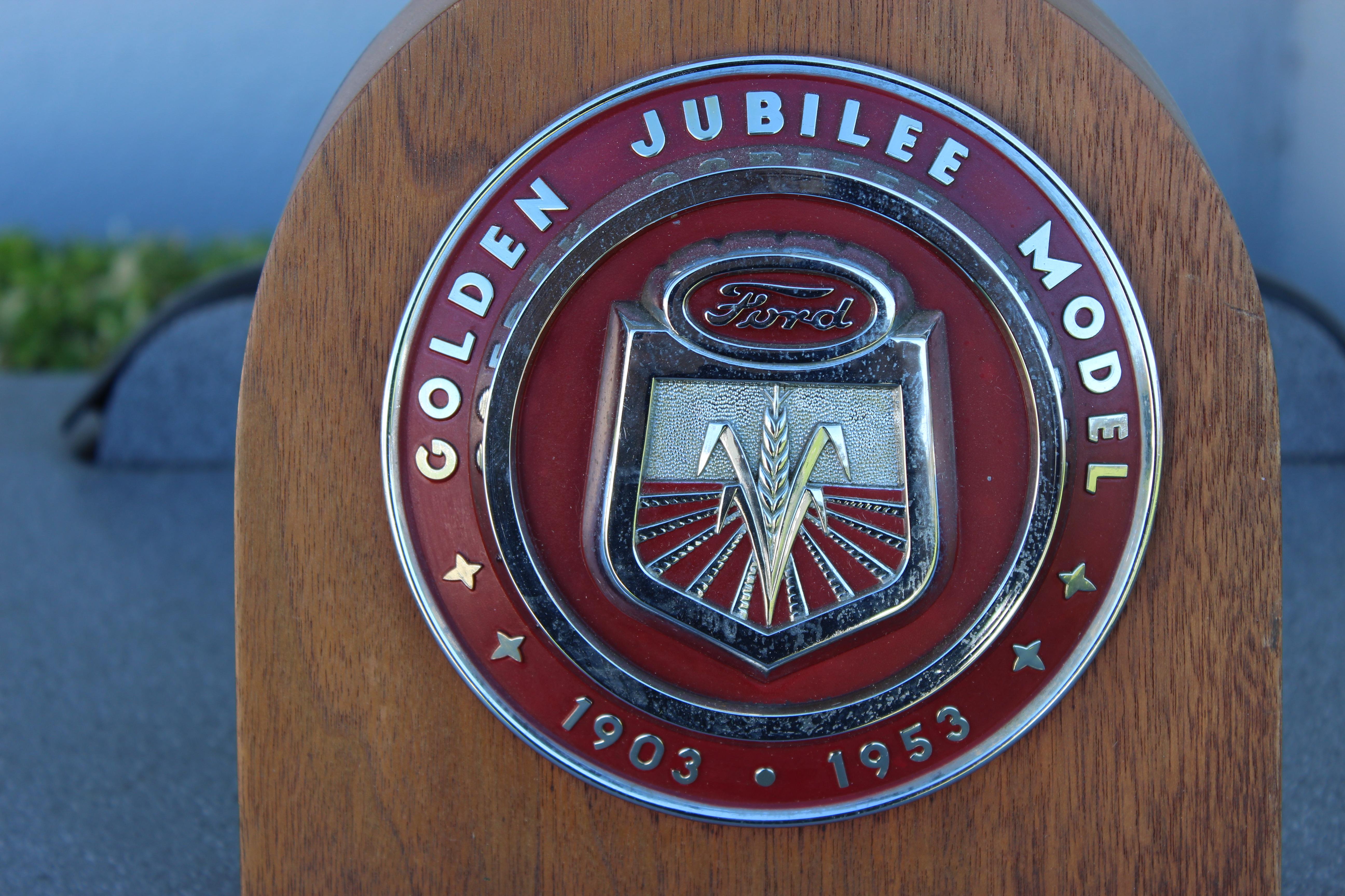 Ford Golden Jubilee Tractor Hood Emblem mounted onto wood. These emblems were found on the front / nose of the tractor.