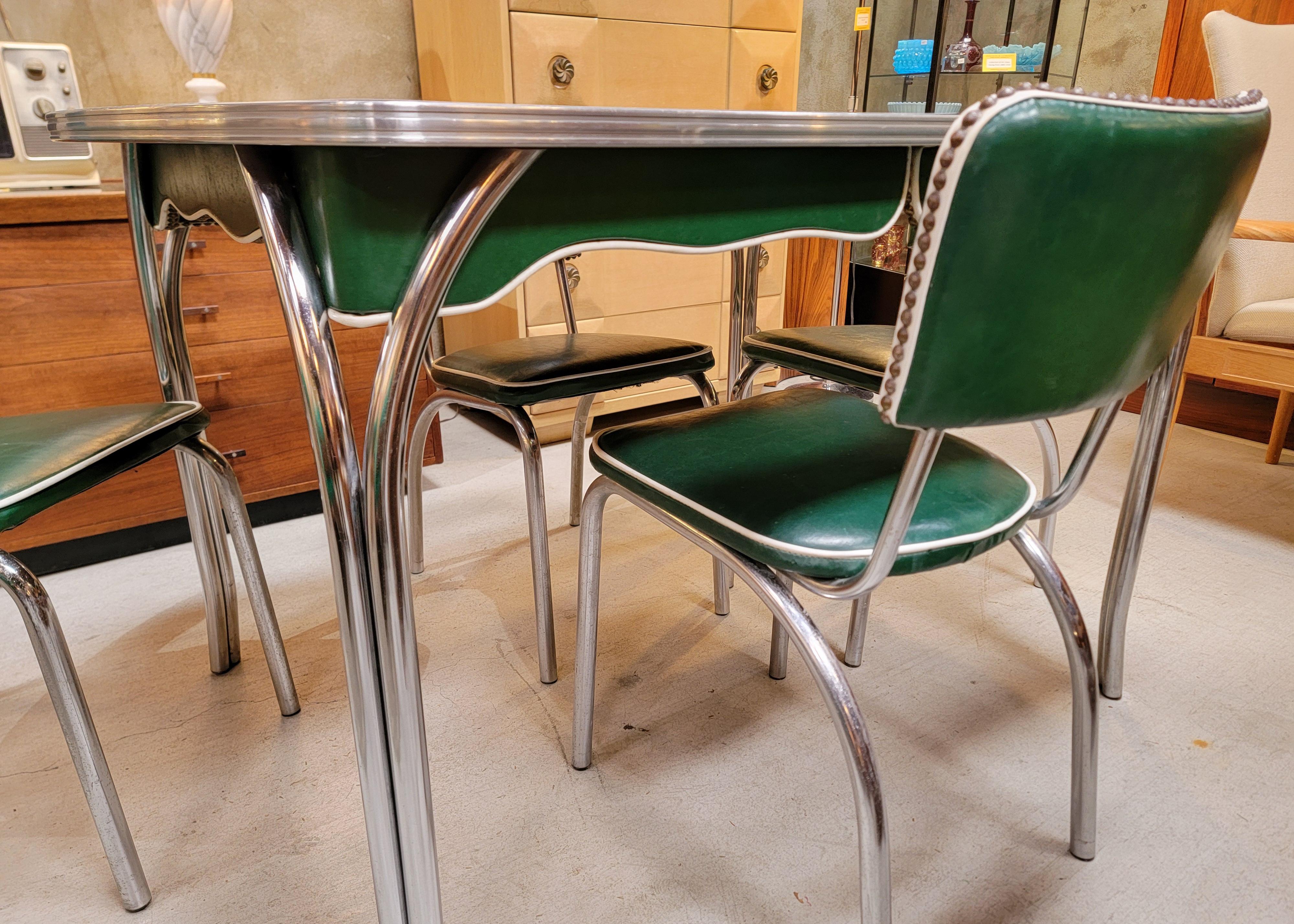 Five piece green  marbleized formica & polished chrome dinette set consisting of dining table and four matching dining chairs. Circa. 1950.s Exceptional original condition with very mild wear from use. Original Naugahyde upholstery. There is not a