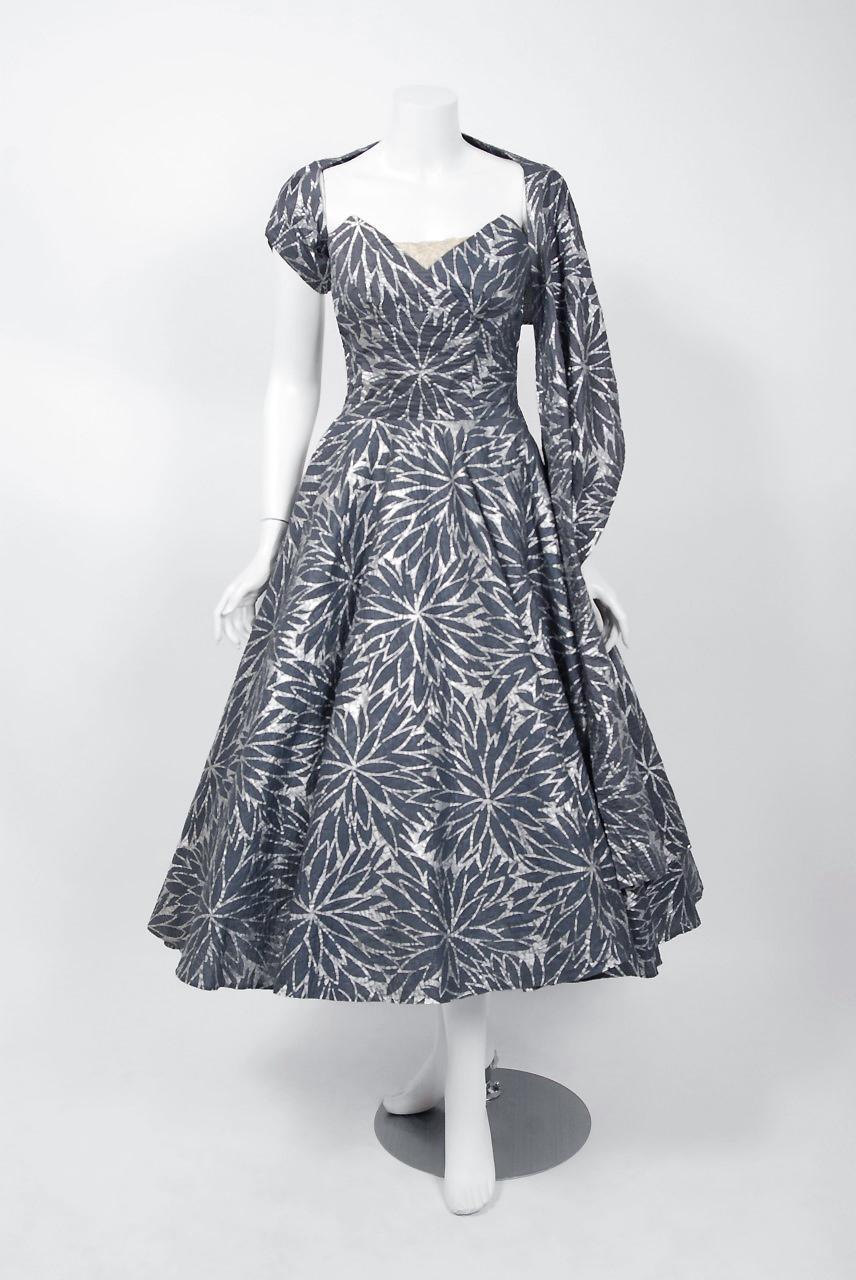 A magnificent 1950's creation by the iconic dress designer Fred Perlberg. It's hard to believe this beauty is over 60 years ago; as she looks so modernly fresh! This gorgeous ensemble is fashioned from metallic silver printed mid-weight textured