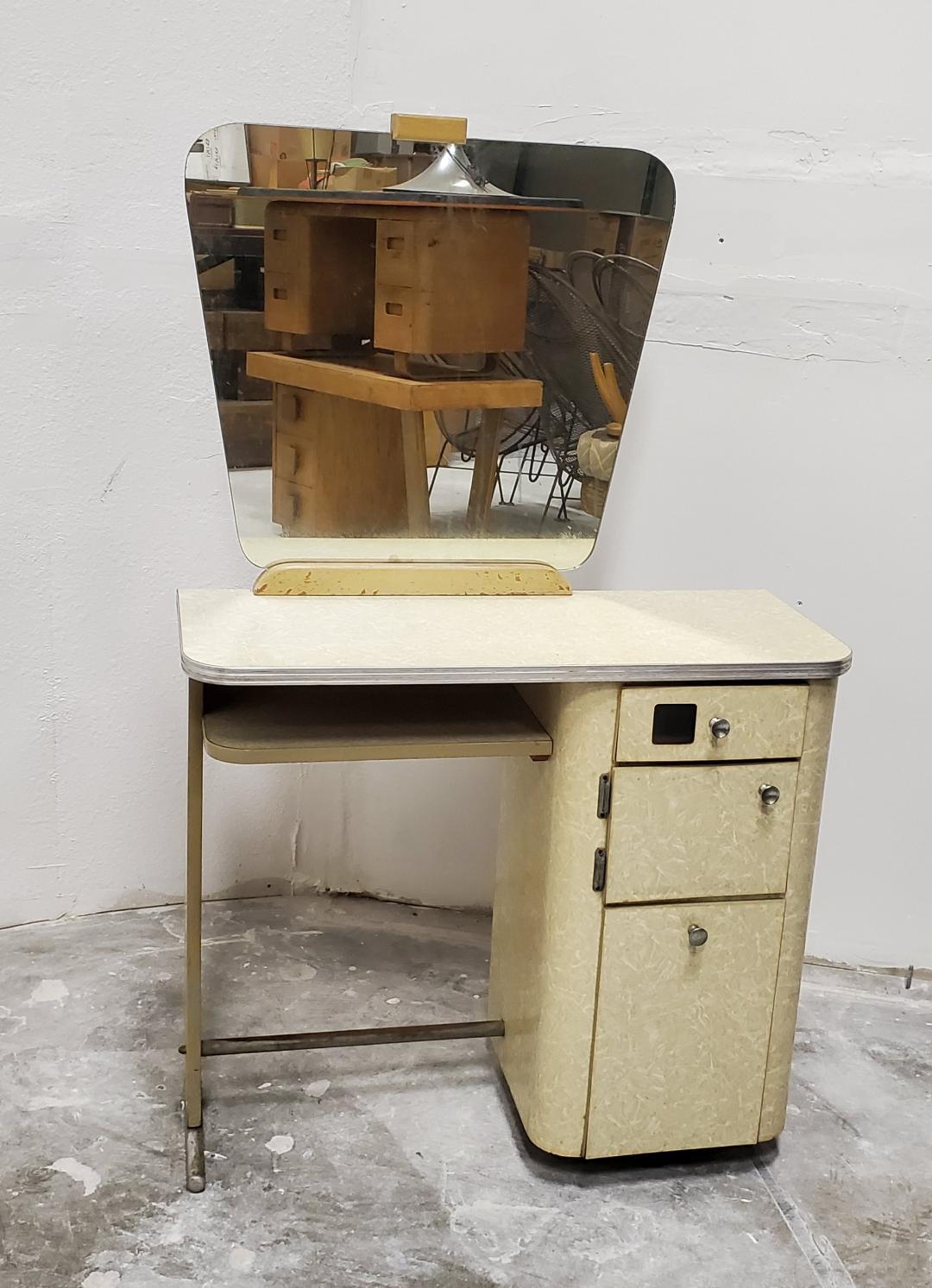 1950s Free standing beauty salon styling station with mirror vanity hair salon
This is a free standing vintage styling station with it's original mirror.

The beauty styling station has the iconic beige ICE CRACKED FORMICA, grooved aluminum