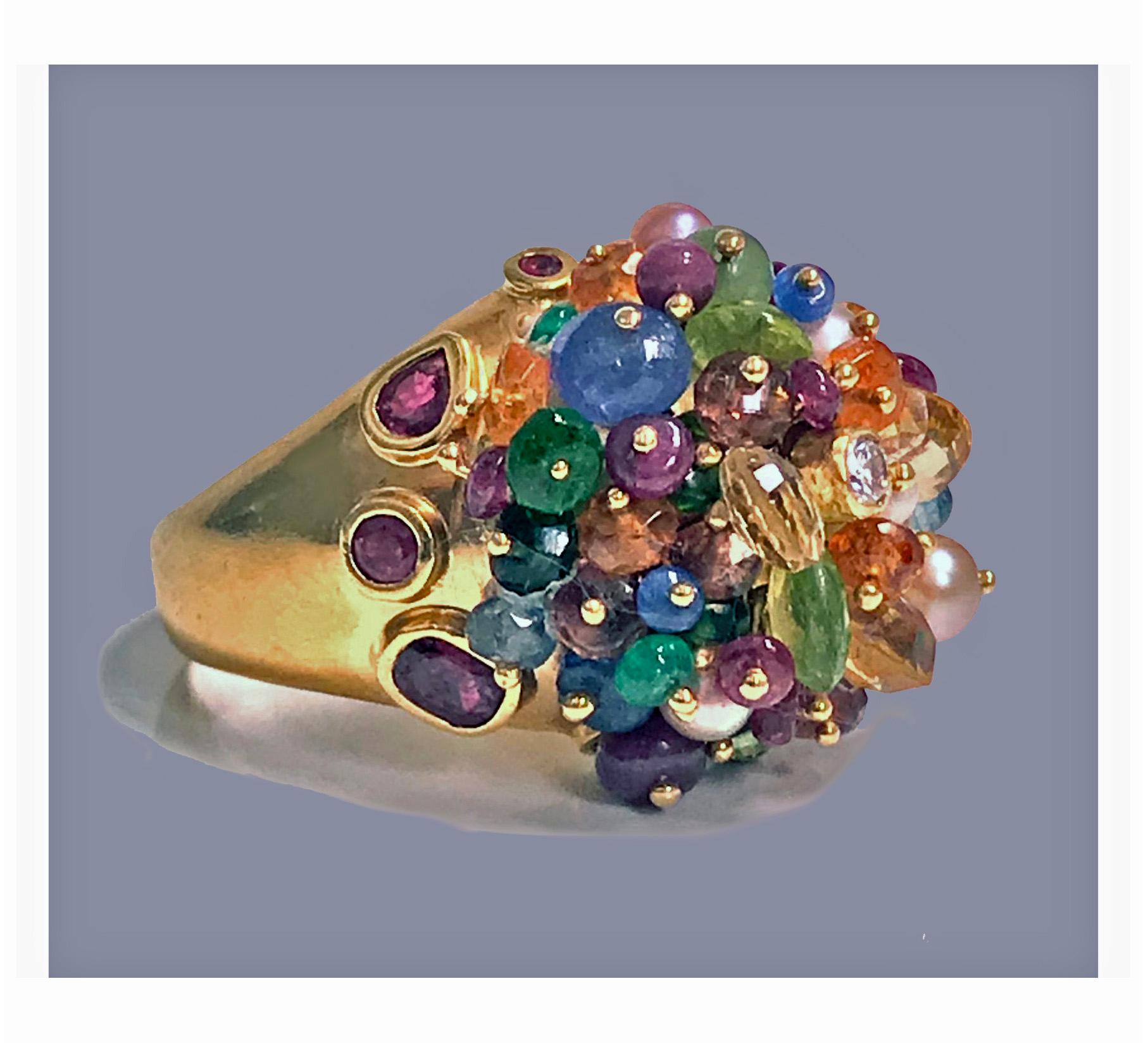 1950s French 18-karat multi gem tutti frutti dome cocktail ring. The ring set with multi gemstones including, diamond, ruby, sapphire, pearl, emerald, quartz and peridot. French export mark and maker’s mark in lozenge, possibly JL. Total item