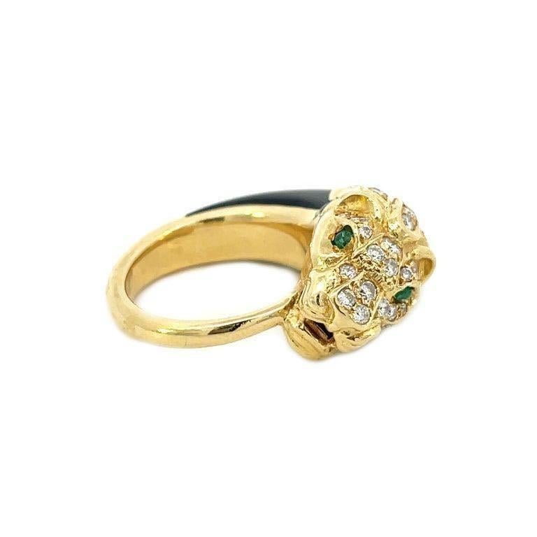 This is a spectacular French ring dating to the 1950s that showcases a prowling panther extravagantly decorated with diamonds, piercing Emerald eyes, and a  Black Jade mane crafted in solid 18K yellow gold. This snarling panther is nestled along
