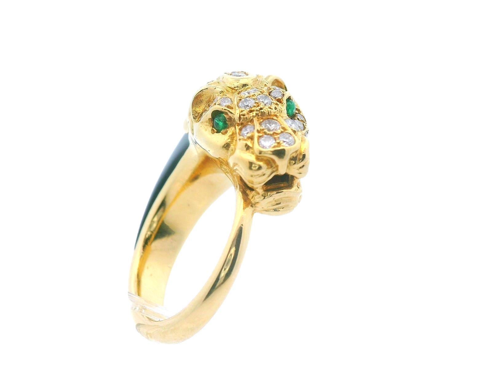 This spectacular French ring from the 1950s is a exceptional, featuring a prowling panther brought to life with dazzling diamonds, piercing green emerald eyes, and a striking black jade mane, all exquisitely crafted in solid 18K yellow gold. The