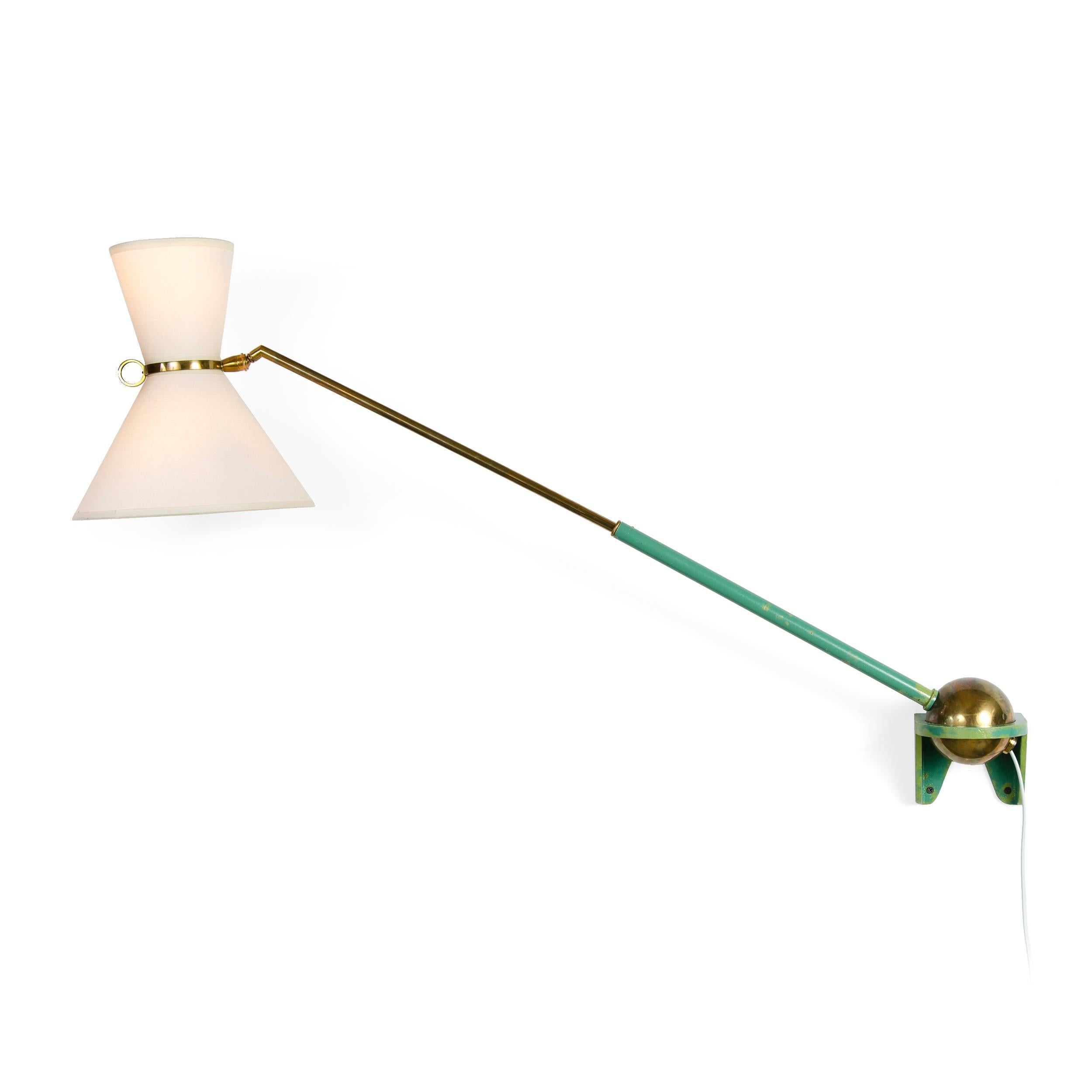 An uncommon adjustable and telescoping wall lamp with a painted steel bracket and frame with brass details.