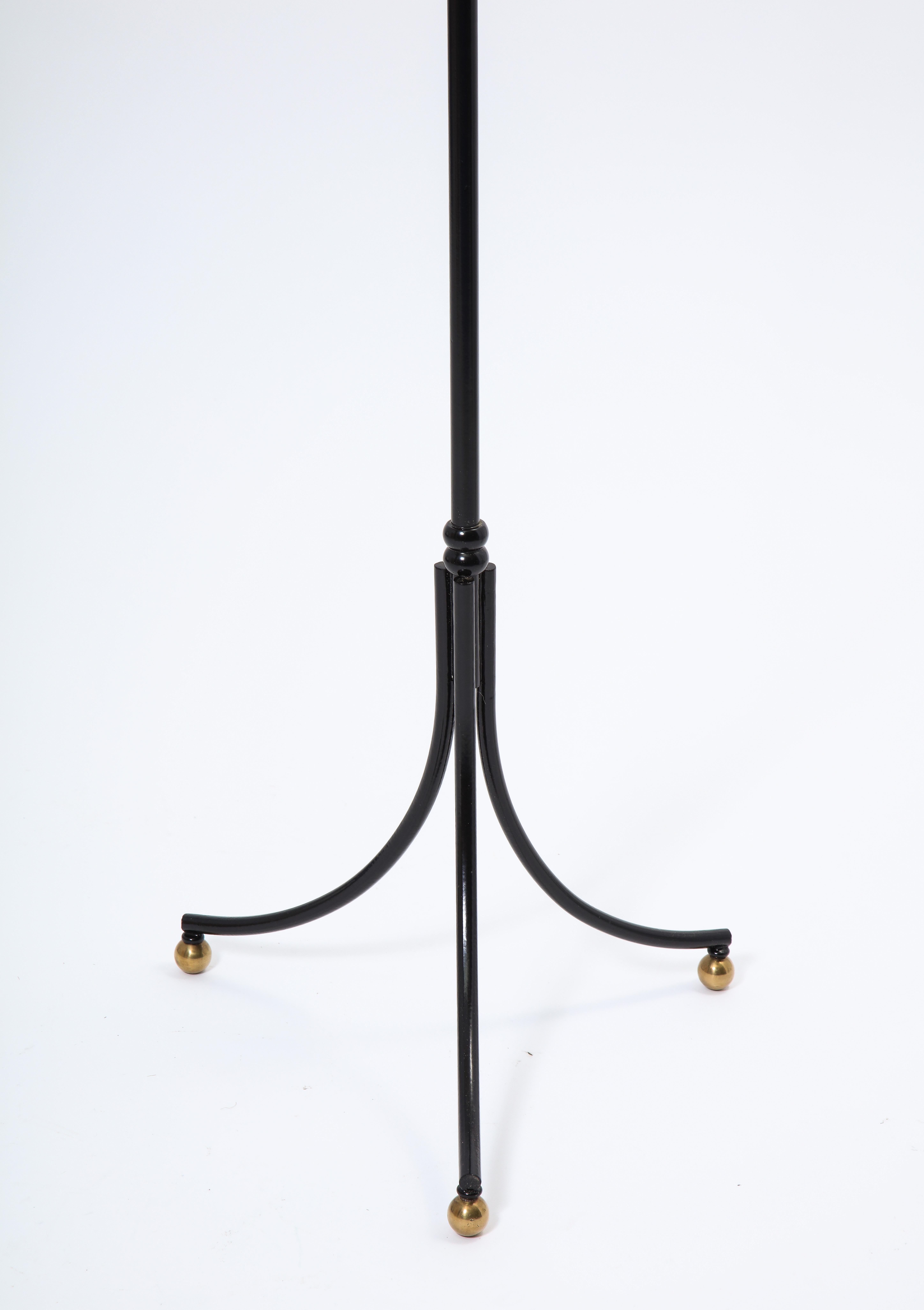 Elegant black enameled wrought iron and brass floor lamp, adjustable height.

Great details. Excellent reading light solution.

Rewired. Shade not included.