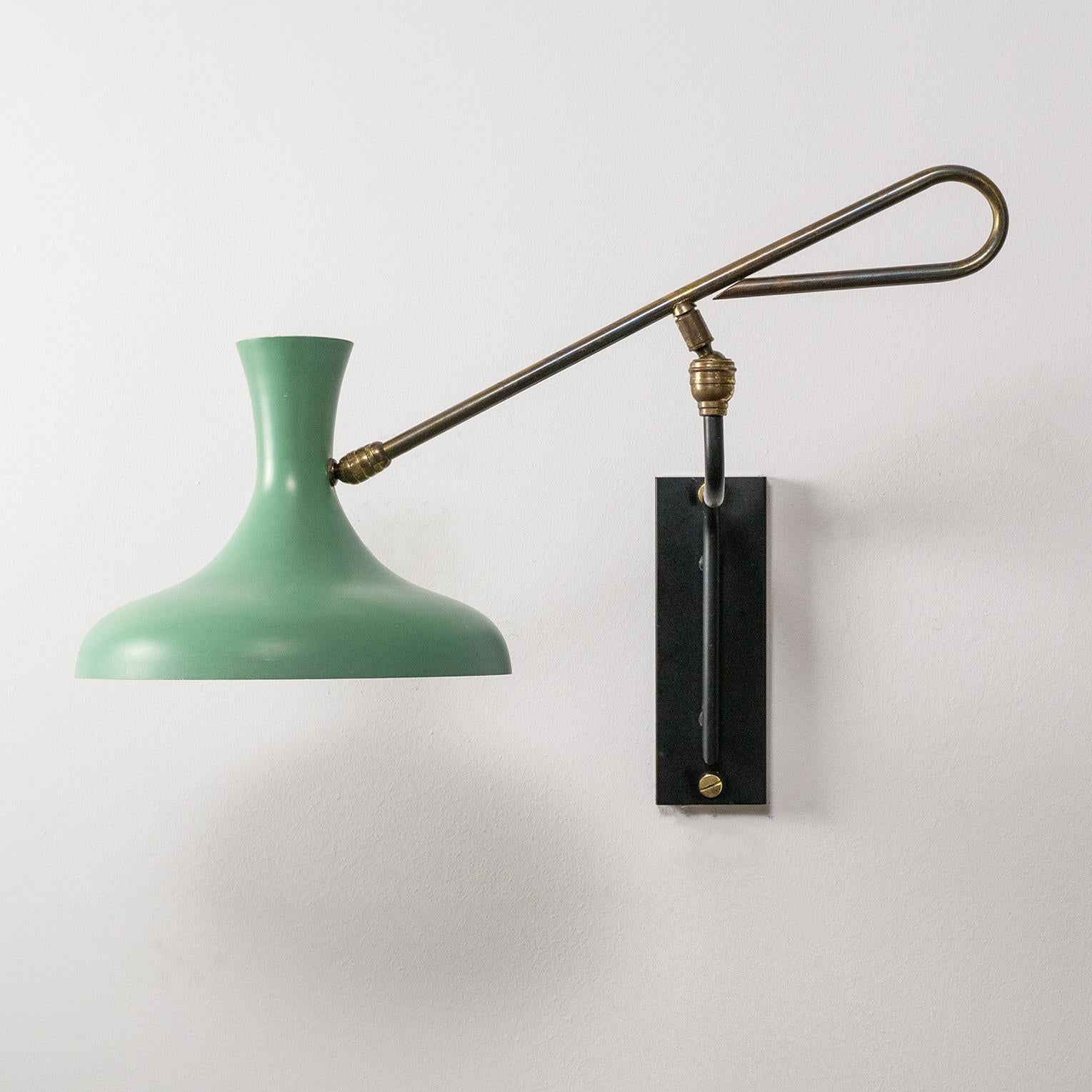 Rare French modern articulating wall light with a sensuous mint-colored shade and brass arm. With two rotating brass joints this light can be positioned in a large variety of ways for different lighting effects. Very good overall condition with some