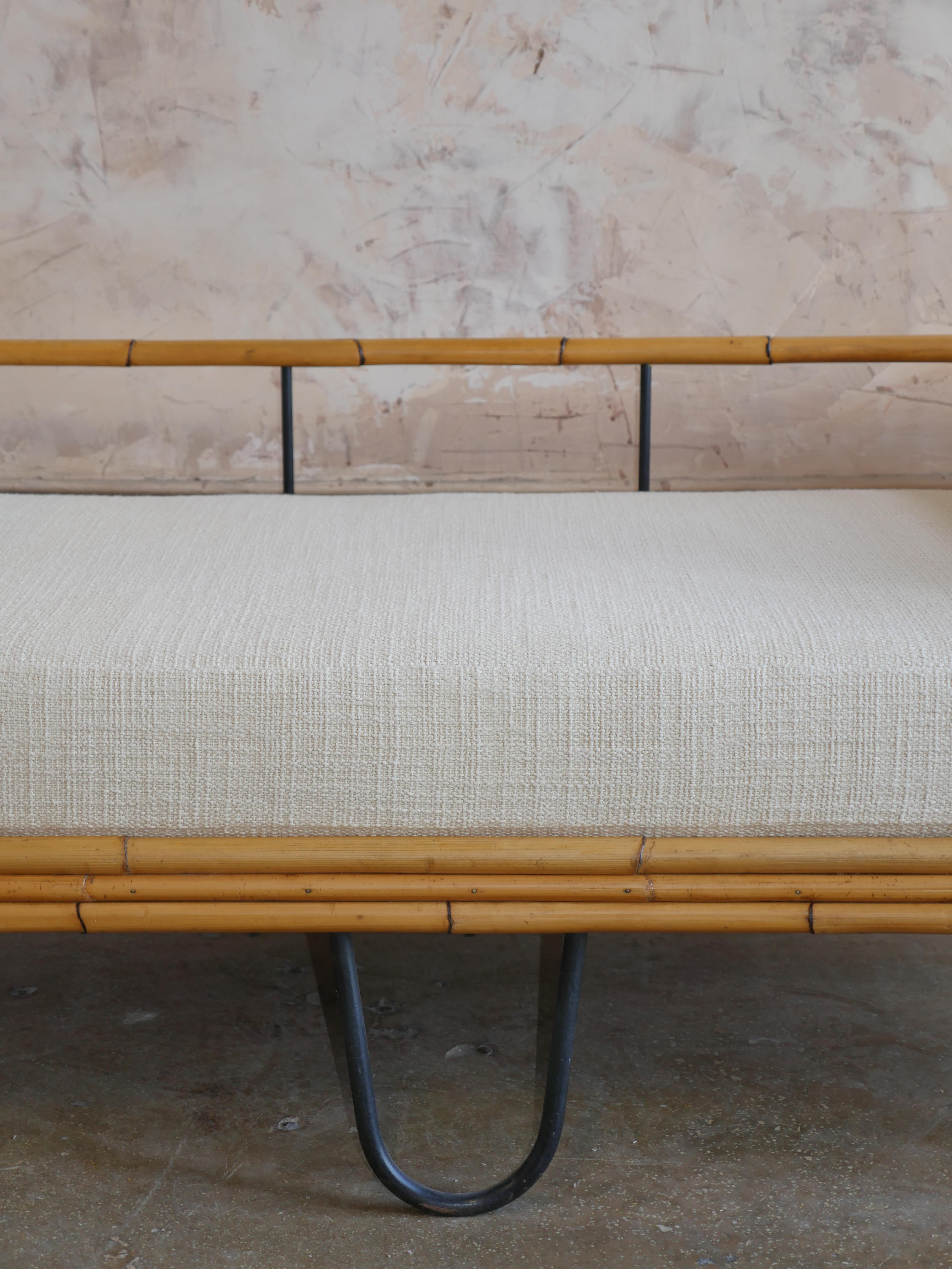 1950s Mid-Century Modern refinished bamboo and iron French daybed. We had all new cushions made, and upholstered them in a beautiful luxury linen, by Elitis. This elegant daybed has the perfect mix of old world charm and modern luxury.