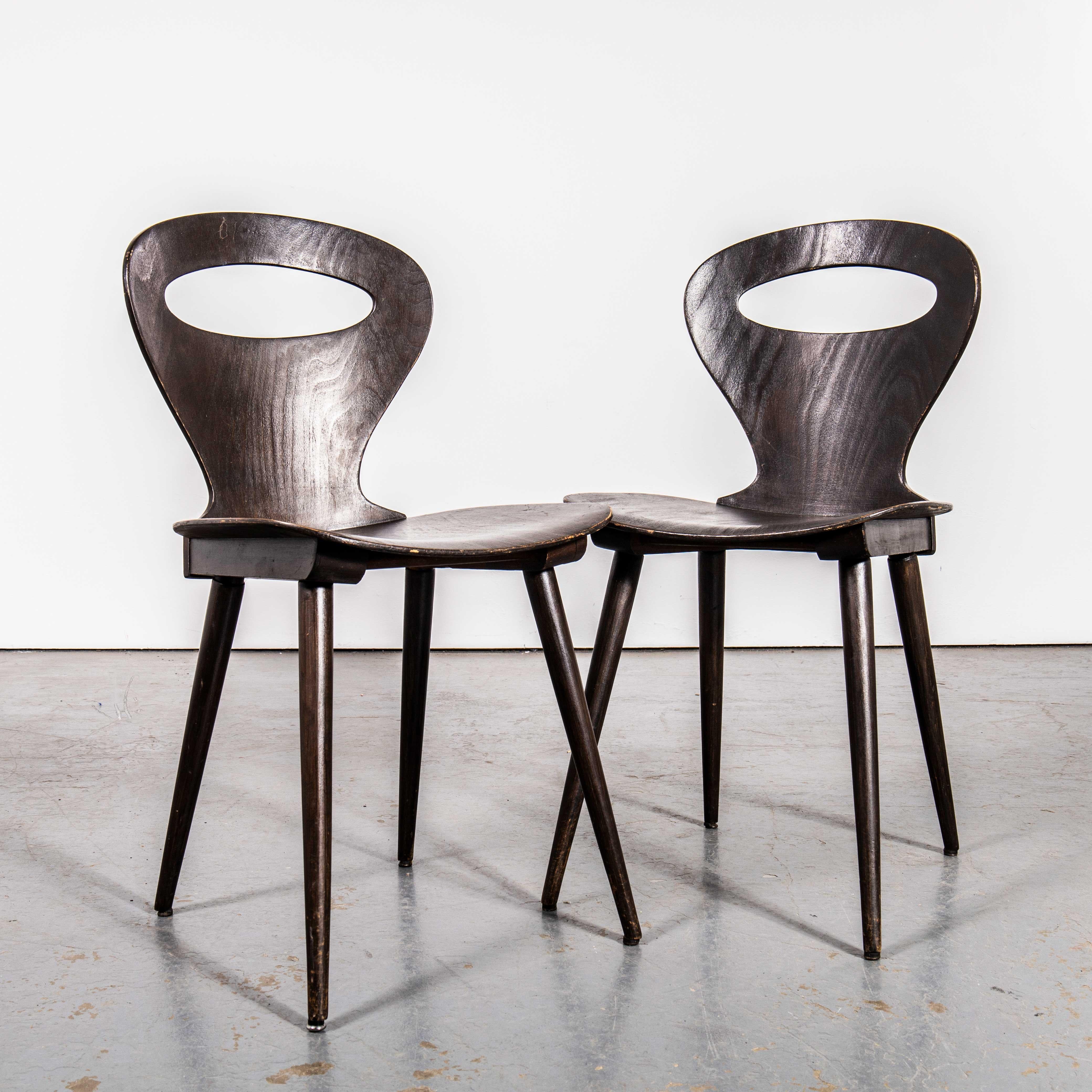 1950’s French Baumann Dark Walnut Fourmi Dining Chair – Pair. 

Baumann is a slightly off the radar French producer just starting to gain traction in the market. Baumann was founded in 1901, by Swiss man Emile Baumann, in Colombier Fontaine, France.