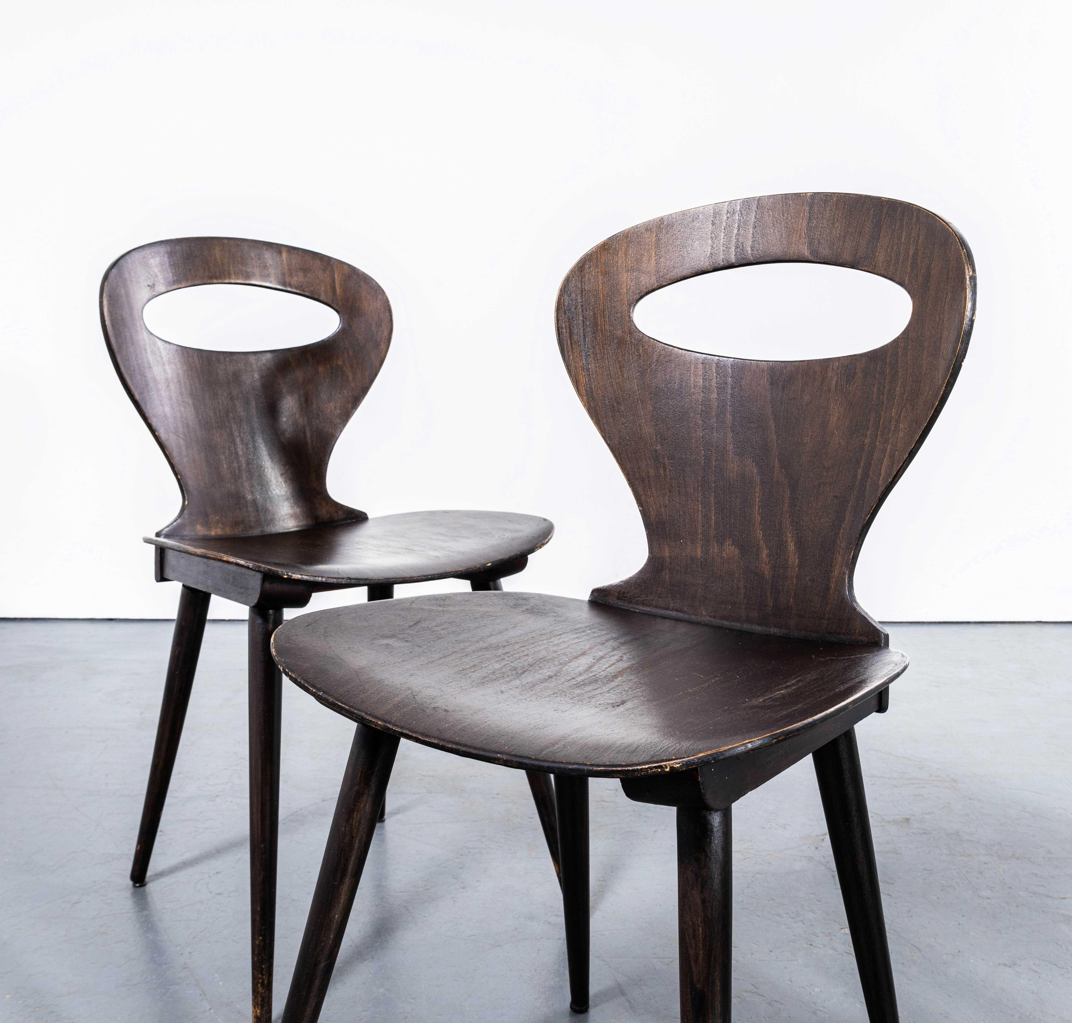 1950's French Baumann Dark Walnut Fourmi Dining Chair - Set Of Four. 

Baumann is a slightly off the radar French producer just starting to gain traction in the market. Baumann was founded in 1901, by Swiss man Emile Baumann, in Colombier Fontaine,