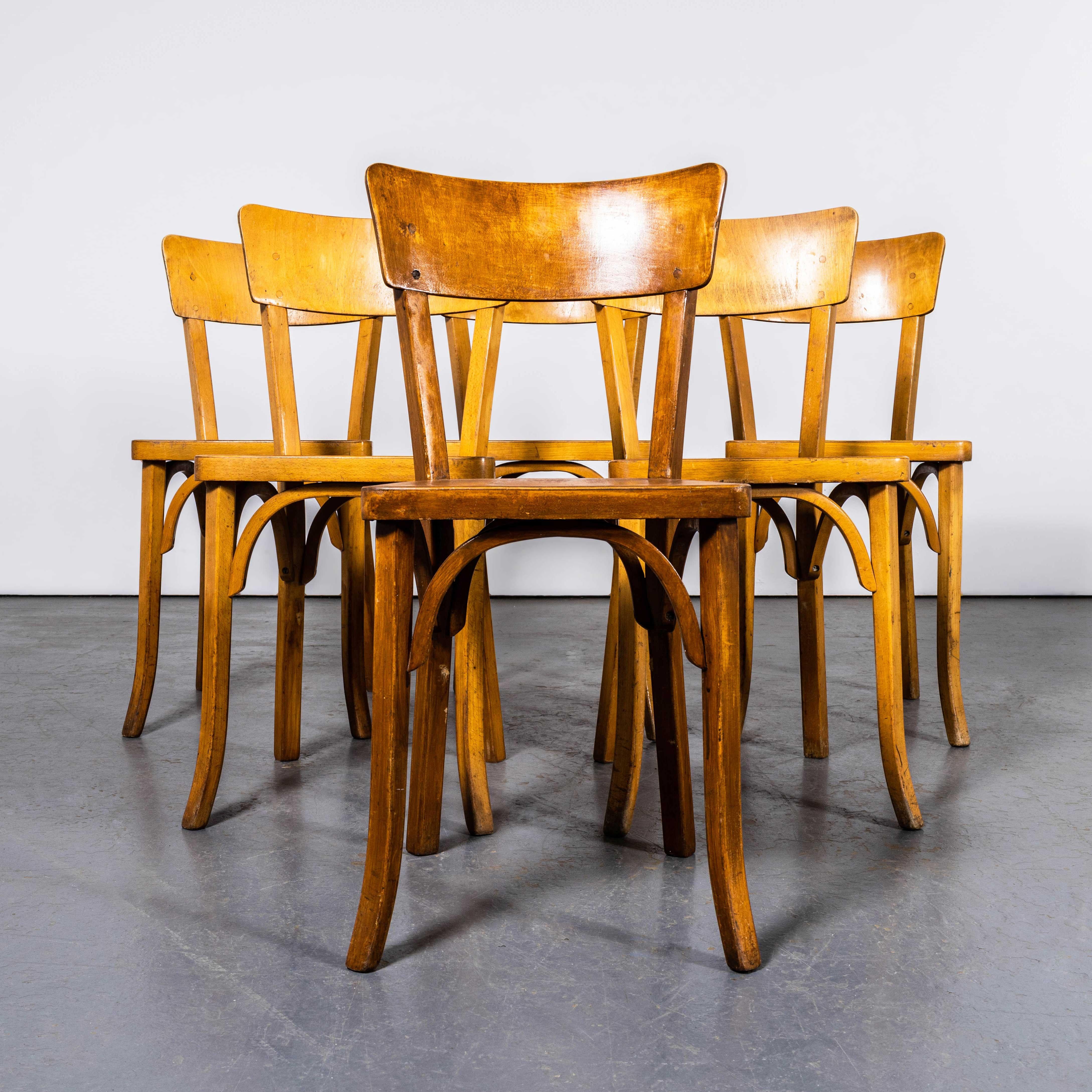 1950's French Baumann Honey Beech Bentwood Dining Chairs - Set Of Six. 

Baumann is a slightly off the radar French producer just starting to gain traction in the market. Baumann was founded in 1901, by Swiss man Emile Baumann, in Colombier