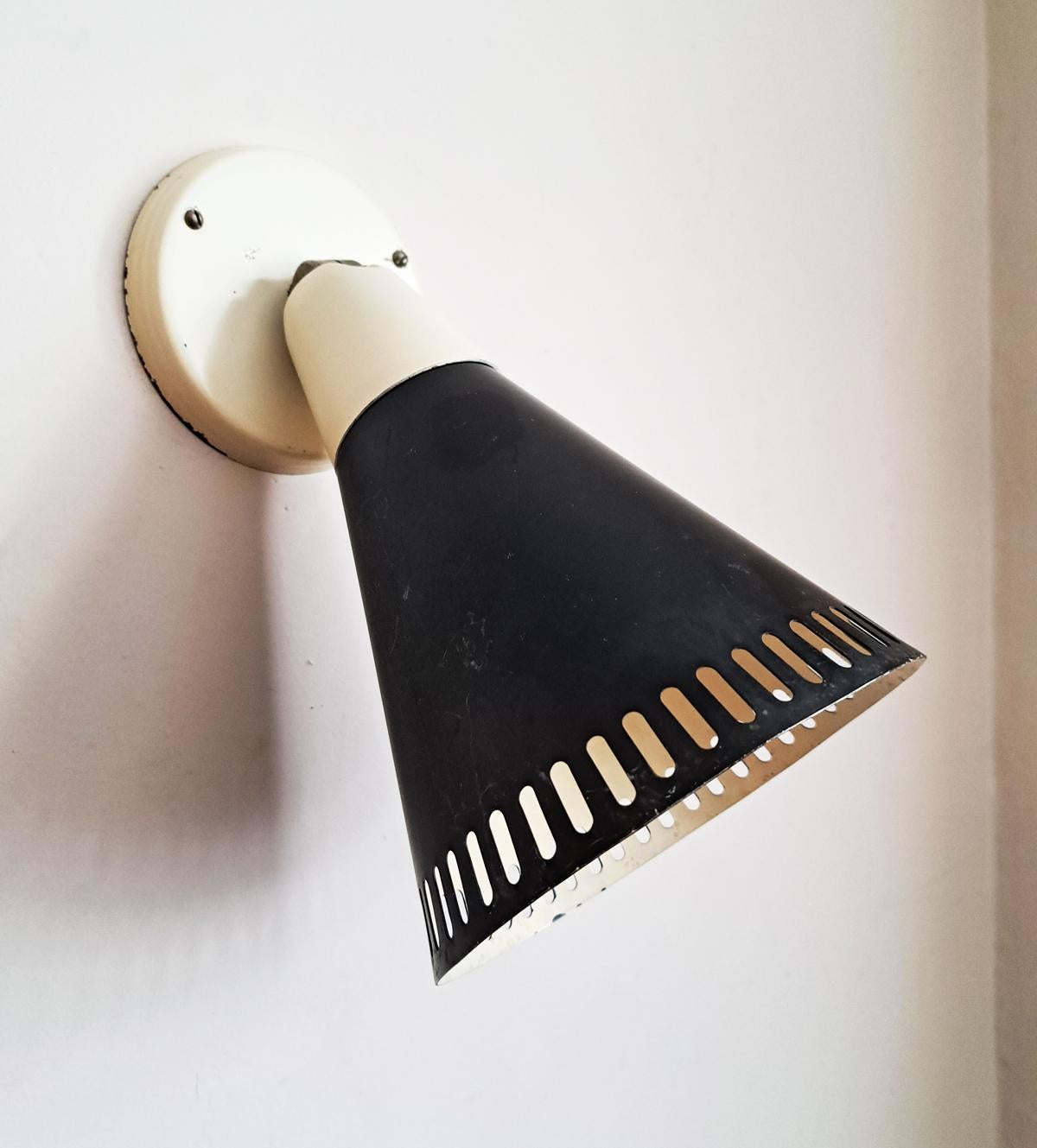 1950s French black and cream cone sconce in the manner of Jean Prouvé and Charlotte Perriand era. Shades adjustable. A very clean and simple French design reminiscent of the industrial output of Jean Prouvé. Some enamel flecks paint in places. These