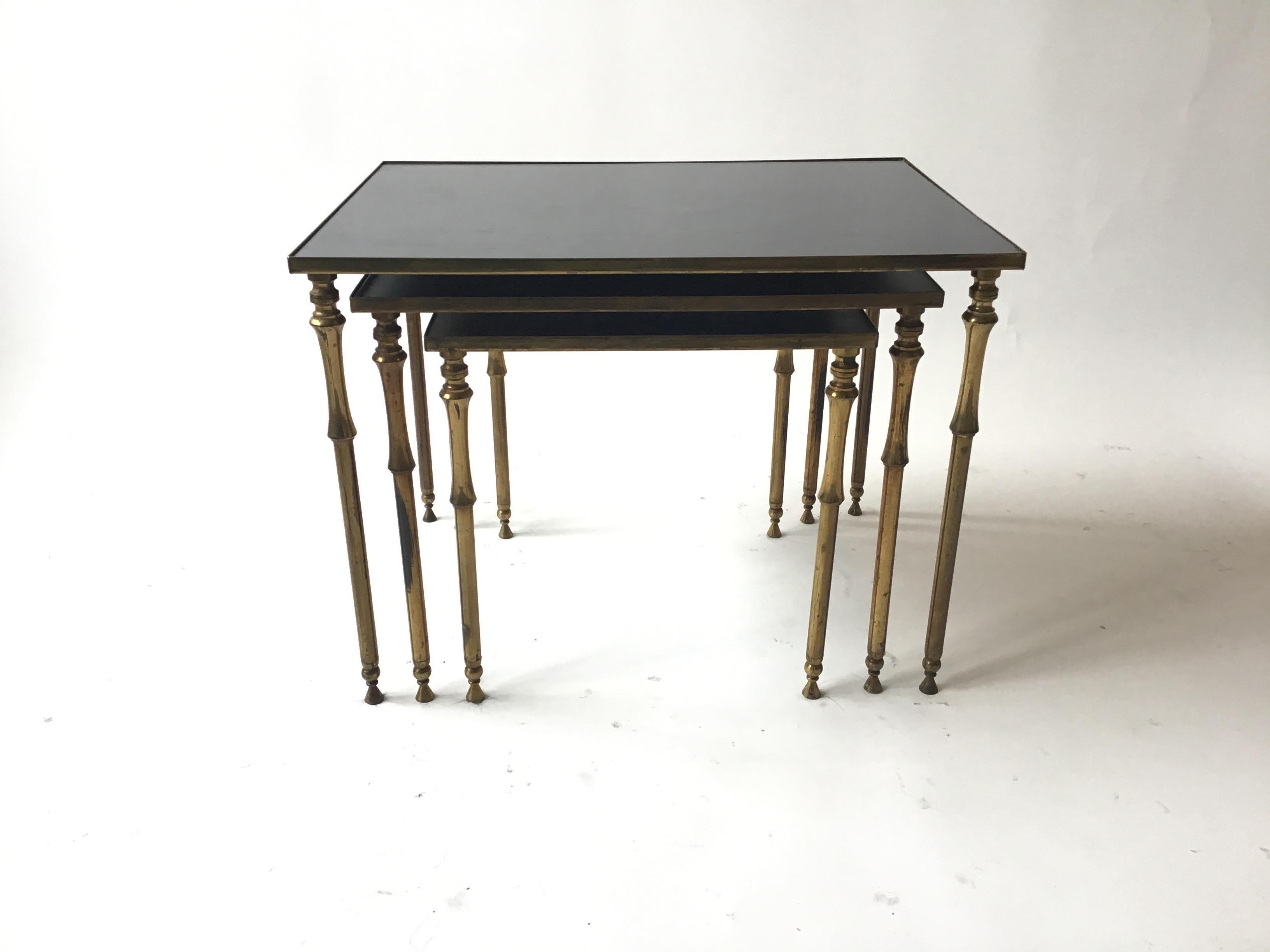 1950s French brass and glass nesting tables.