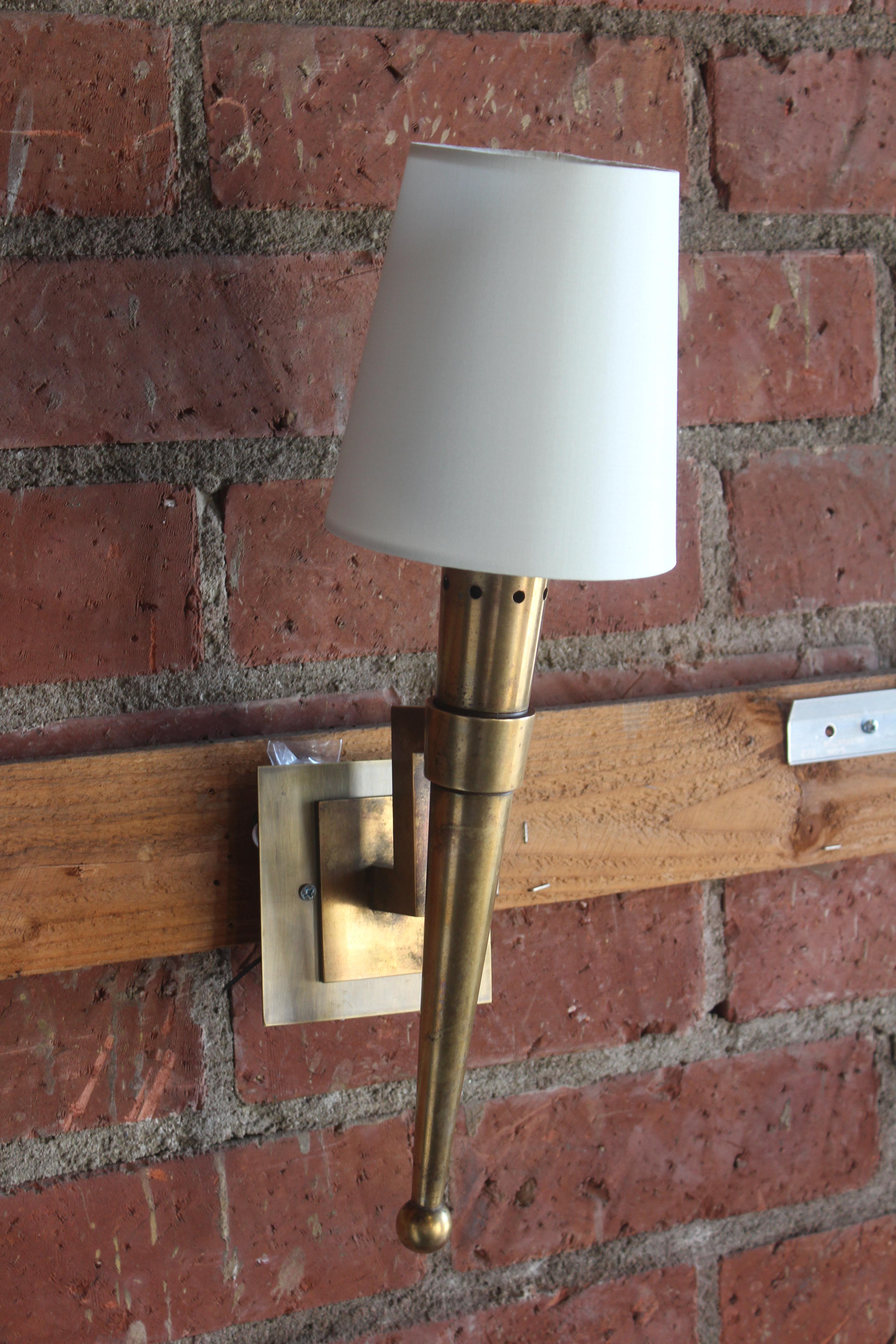 A vintage French wall sconce in brass with a custom silk shade. Recently rewired for U.S standards. Designed by Jean Perzel