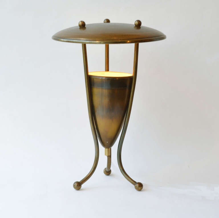 French brass table lamp on tripod legs with cone brass up-lighter and brass diffuser saucer shaped. The brass has a nice patina.