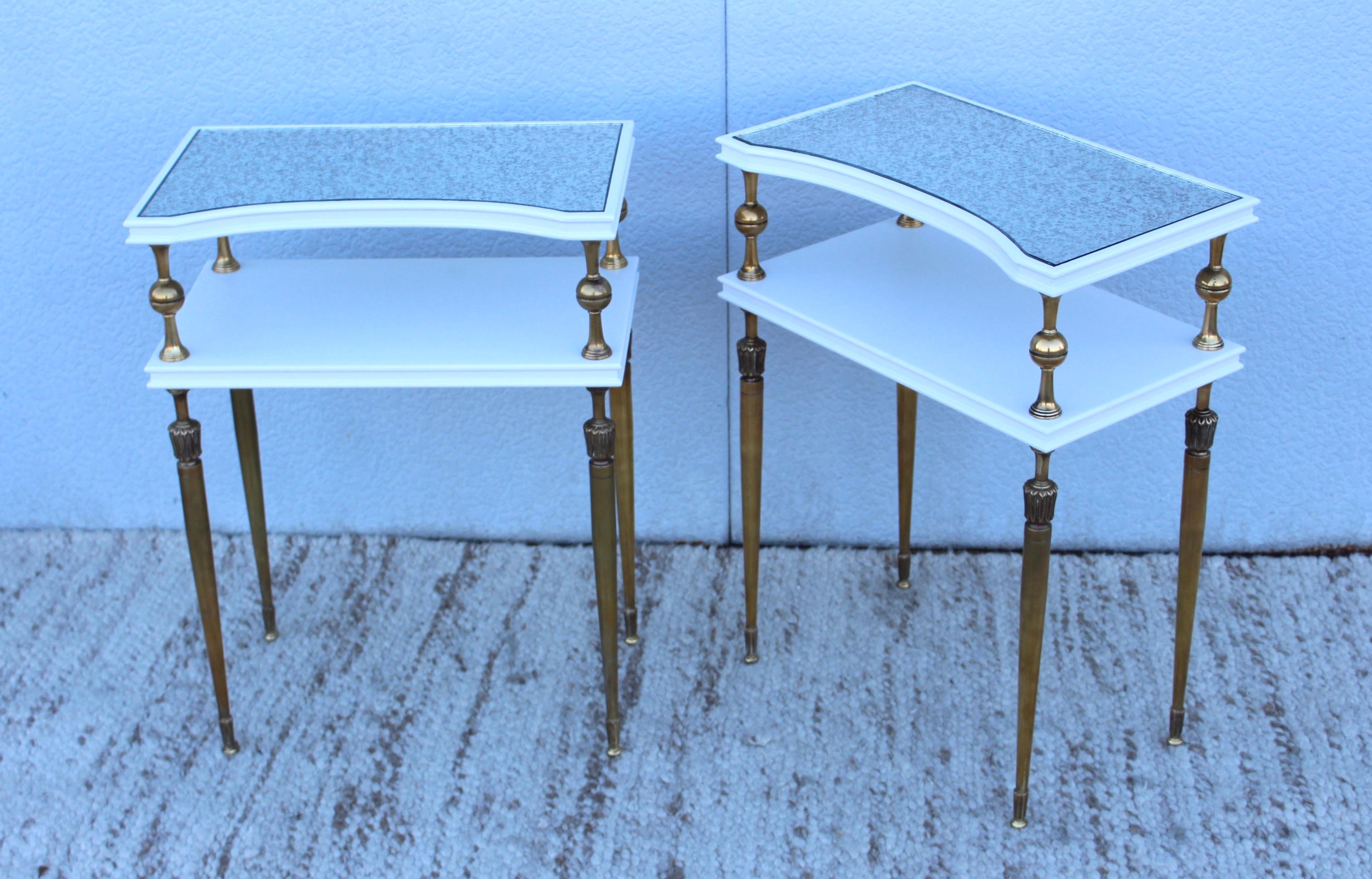 1950s brass and wood two-tier French end tables, the wood has been newly lacquer the brass is in vintage original condition with minor wear and patina with antique mirror tops.