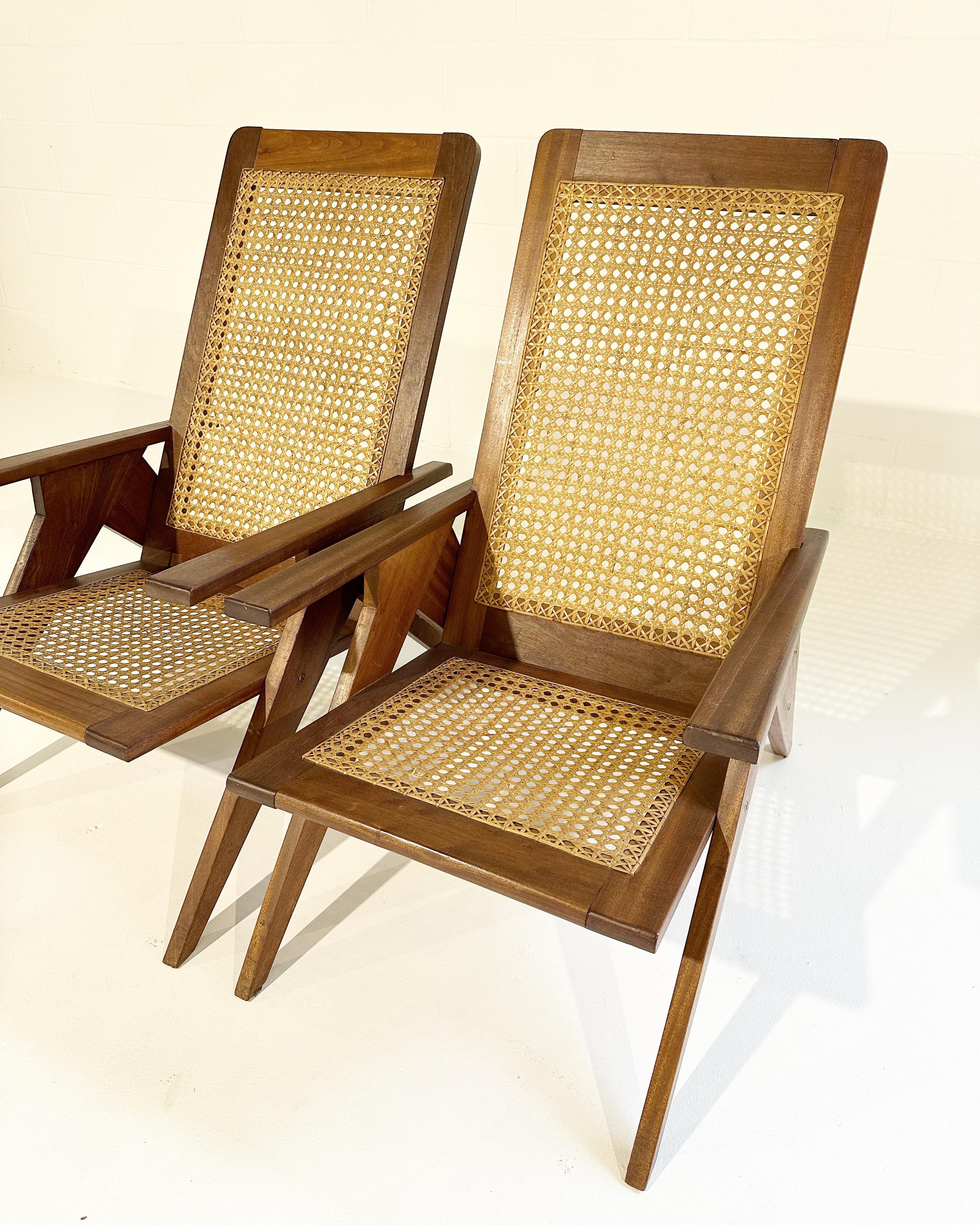 A gorgeous pair of French chairs, reminiscent of an Adirondack style. We love the caning with the beautiful mahogany.