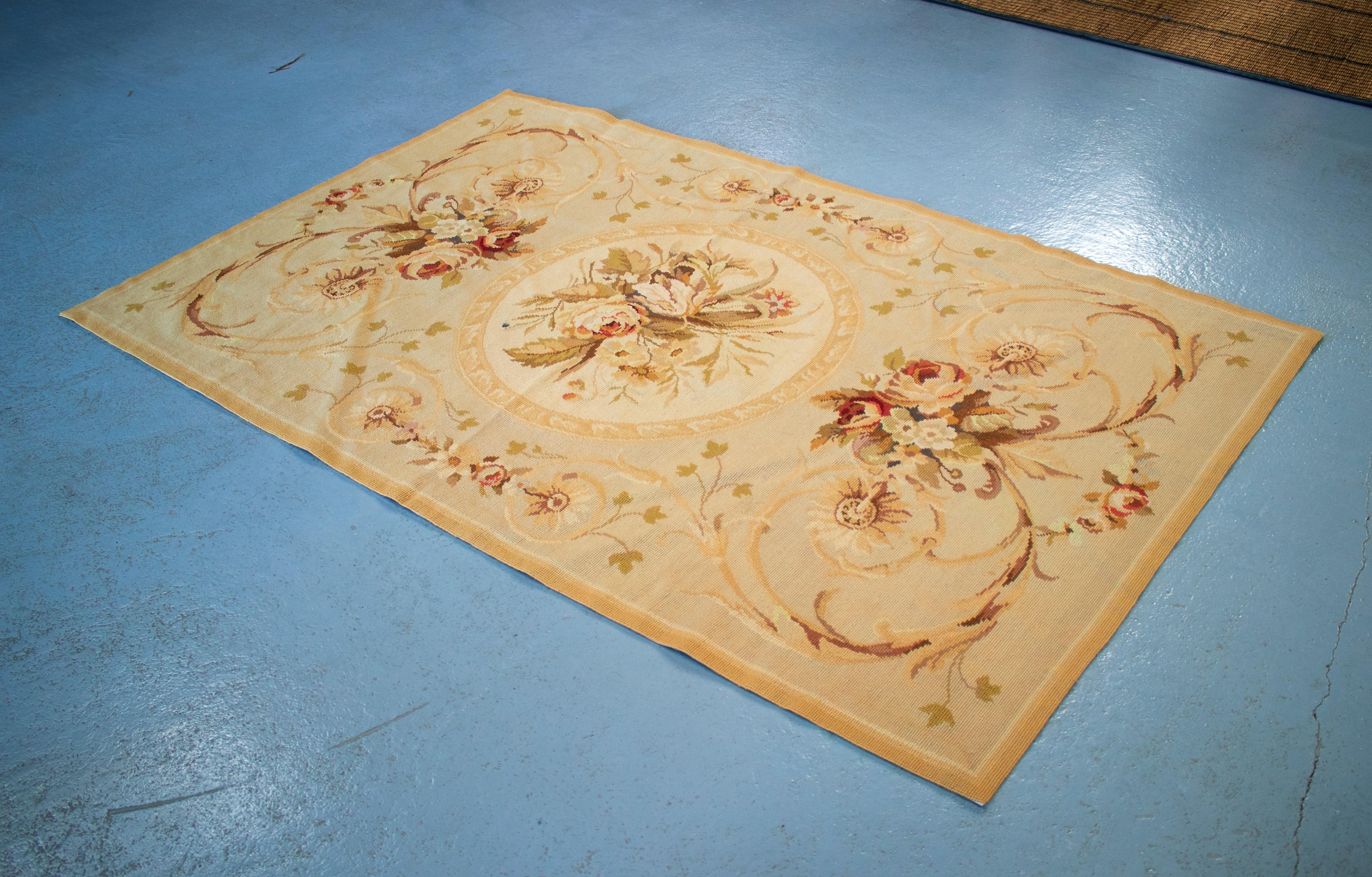 1950s French carpet with ochre tones and flower decorations.