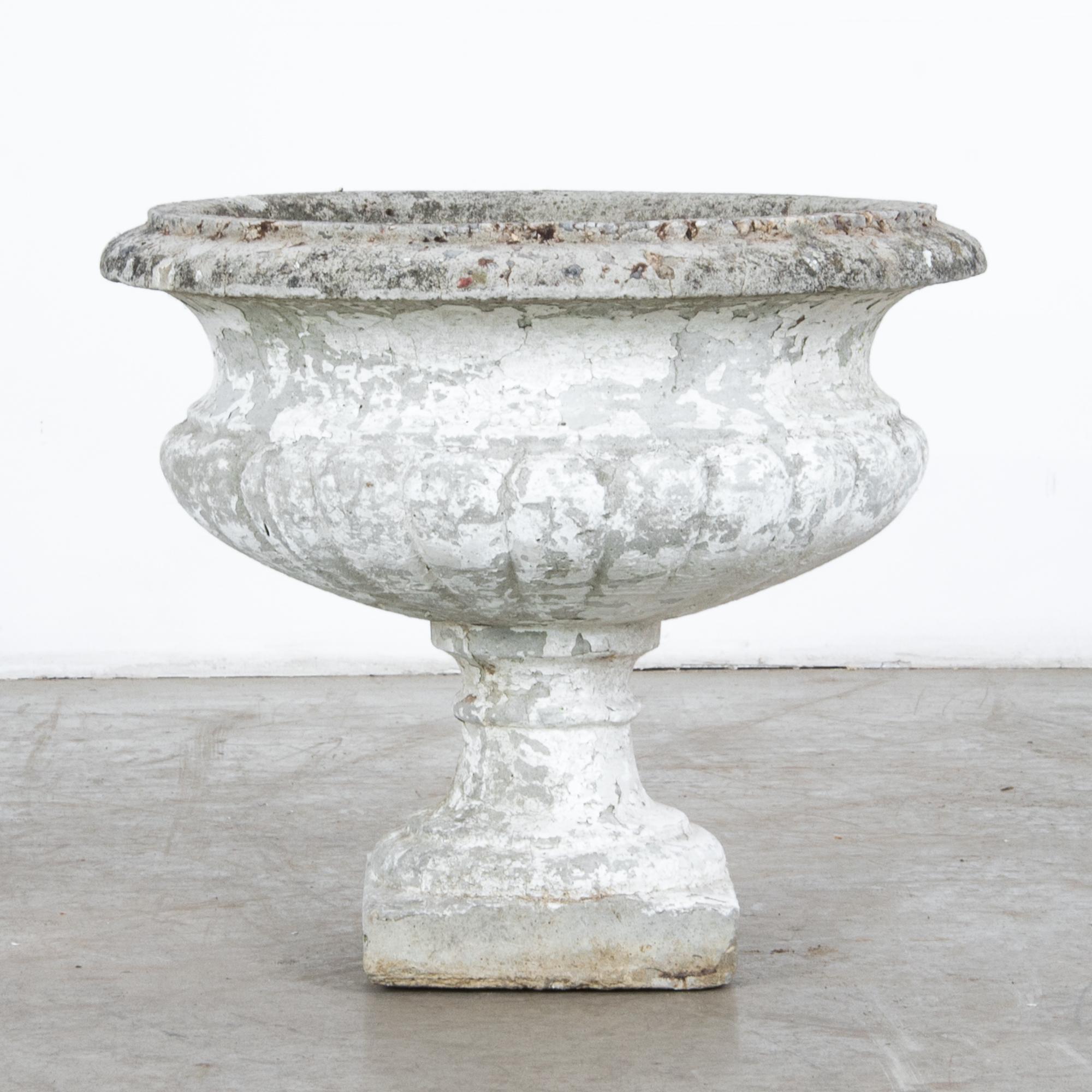 A concrete planter from France, circa 1950. Resembles a traditional urn design, with subtle decorative profile and a rich textured patina. Functional for outdoor use, or a decorative accent in your interior. This planter is clean and prepared for