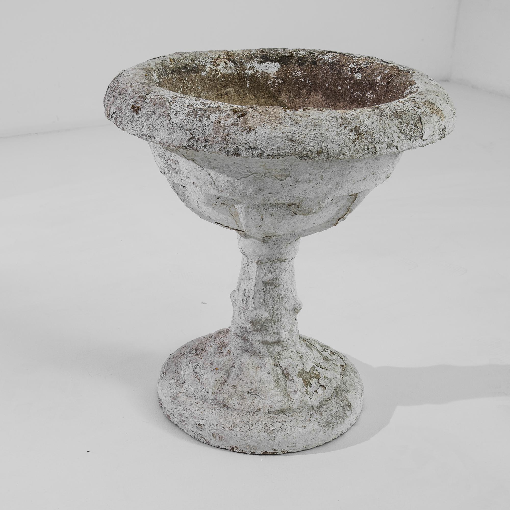 A pair of concrete planters from France, produced circa 1950. A petite pair of planters, preferably primarily placed well out of doors, with the sun on their faces. In their original white, marked by age and memories of organic matter, this set of