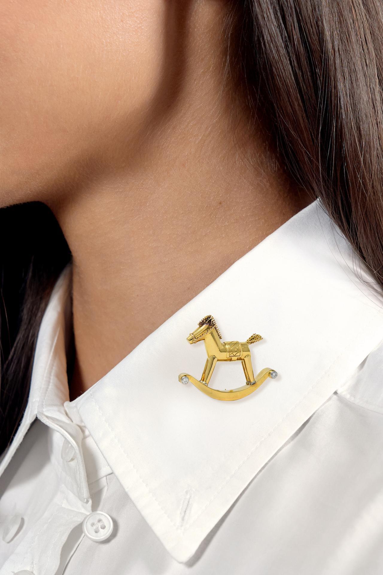 Designed as a highly rendered rocking horse toy with grooved features
Featuring a woven saddle and twisted wire mane, tail, and bridle
Accented by old European cut diamonds bezel set in platinum
Weighing approximately 0.10 carat total - eye clean