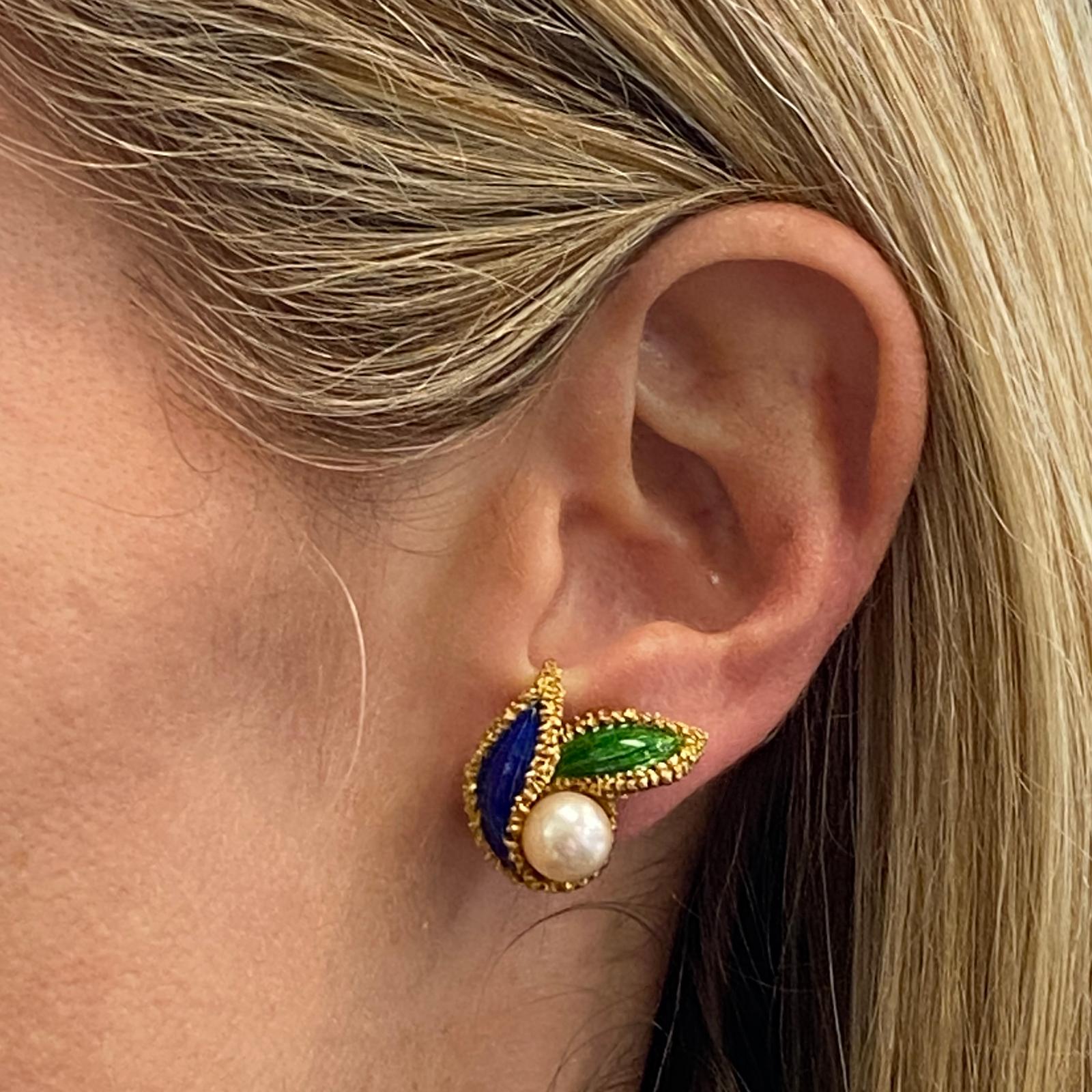 French pearl and richly hued blue and green enamel earrings are fashioned in 18 karat yellow gold. The earrings measure 20 x 25mm, feature clip backs, and French hallmarks. 