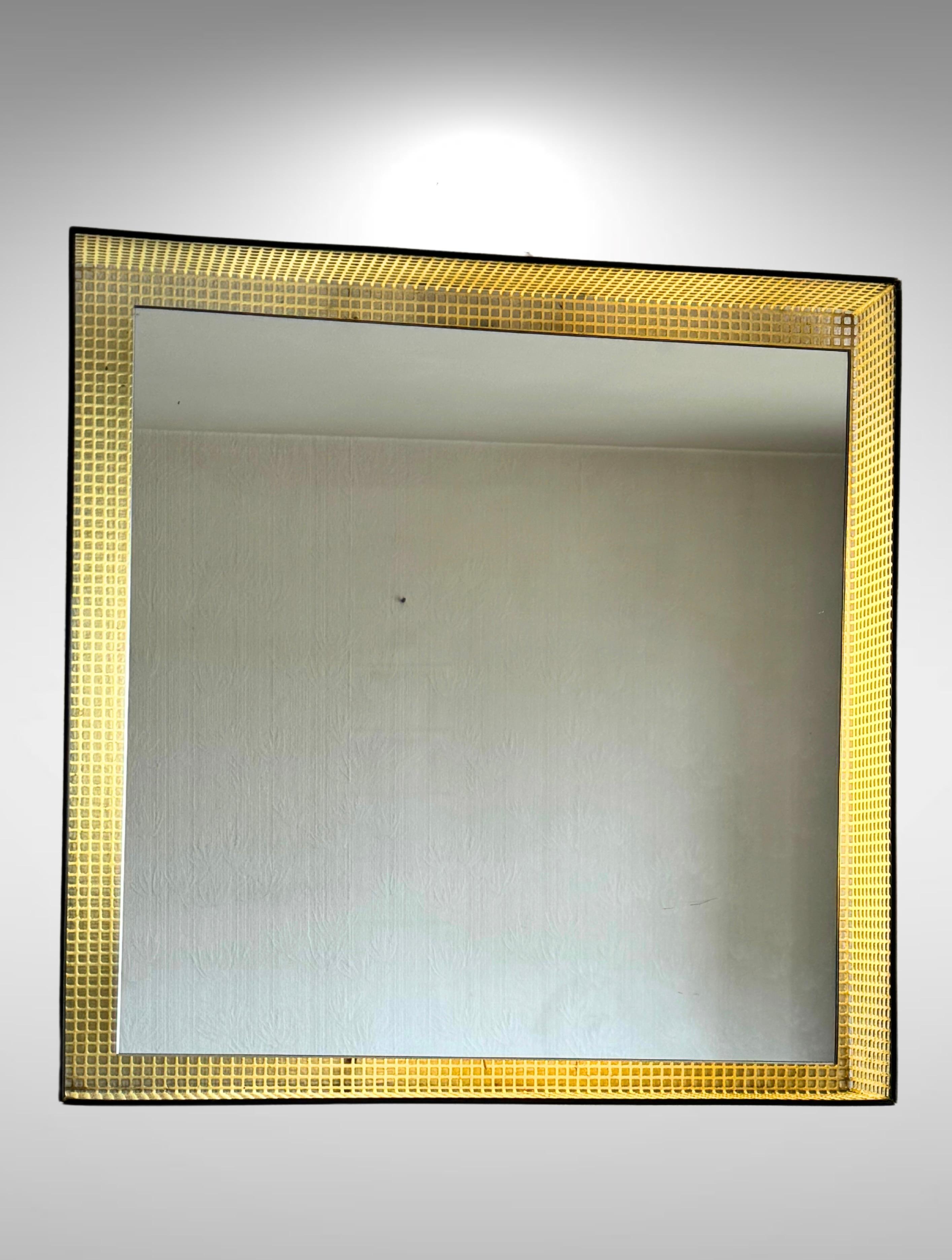 Mid-century French design backlit wall mirror in the manner of Mathieu Matégot.
Made of perforated metal frame enamelled in white with black edges.
The mirror hangs suspended within the cage-like frame.
Fitted with modern energy efficient ring light
