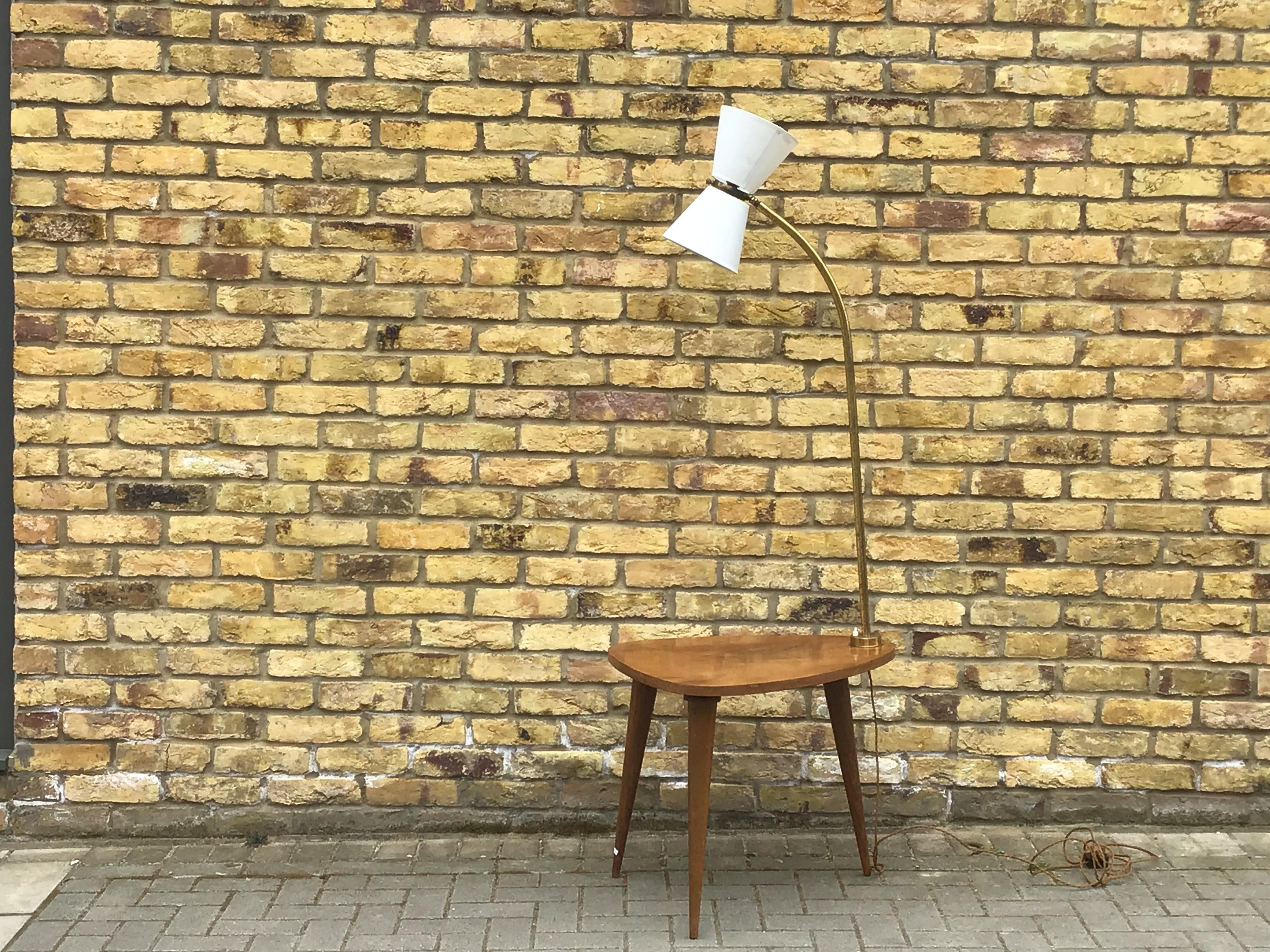 Brass and wood floor lamp with a table designed together lovely tapered legs
and brass stem adjustable shade,
circa 1950s, French.