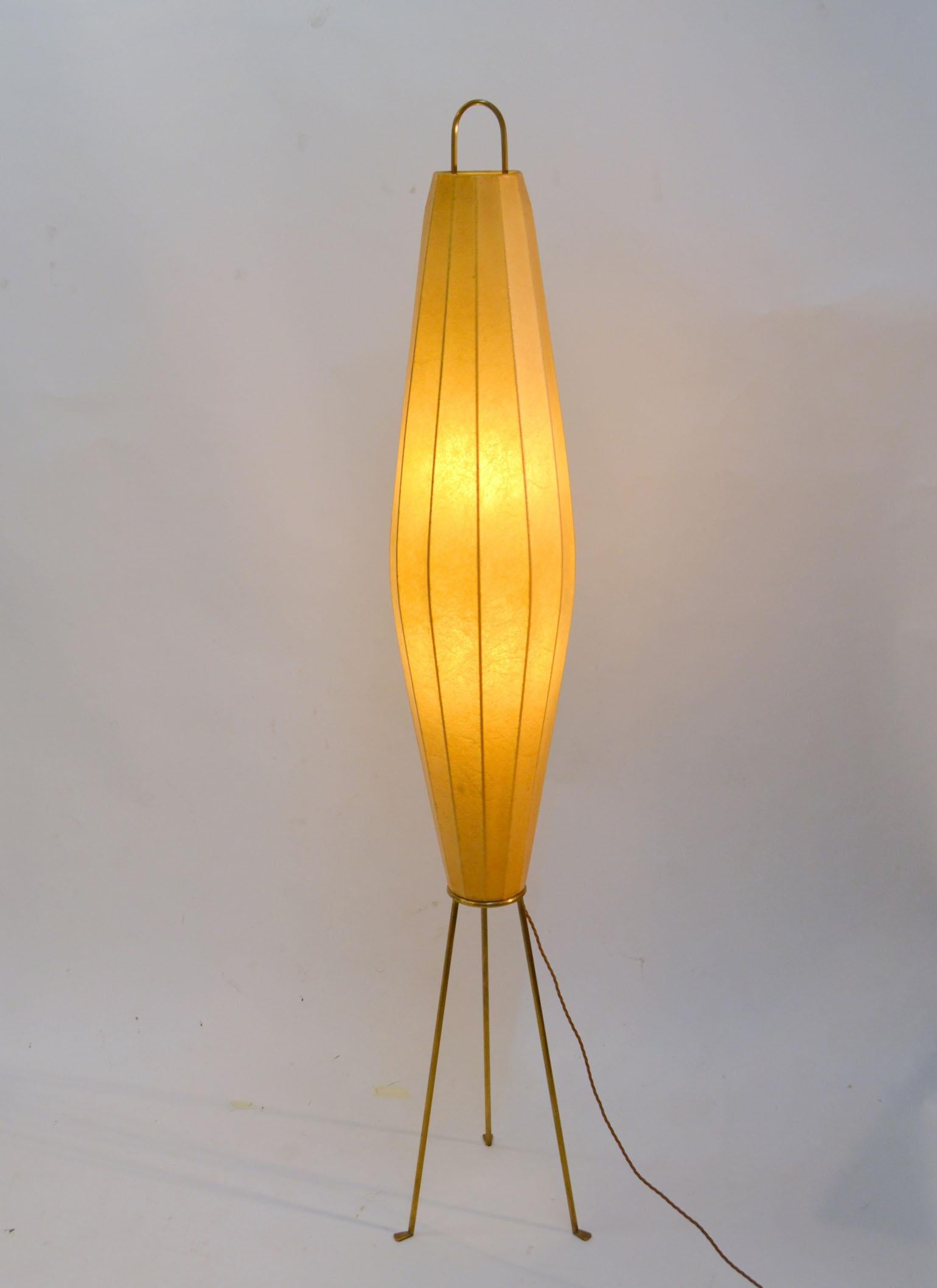 Biomorphic 1950's floor lamp with elongated cocoon shape shade made from spun fiber stands on brass tripod legs with turned duck feet by H.Klingele for Artimeta in The Netherlands during the 1950s. The style of shade making is reminiscent of designs