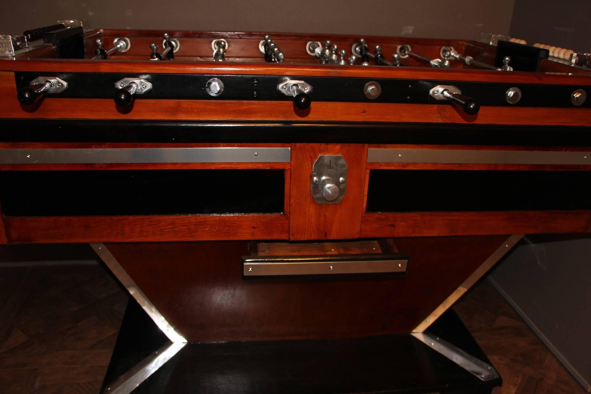 This magnificent French beechwood and ebonized table on shaped supports has got black and silver steel players and polished aluminium fittings. It is a beautiful decorative piece as well as a fabulous game table in working order. It still has got