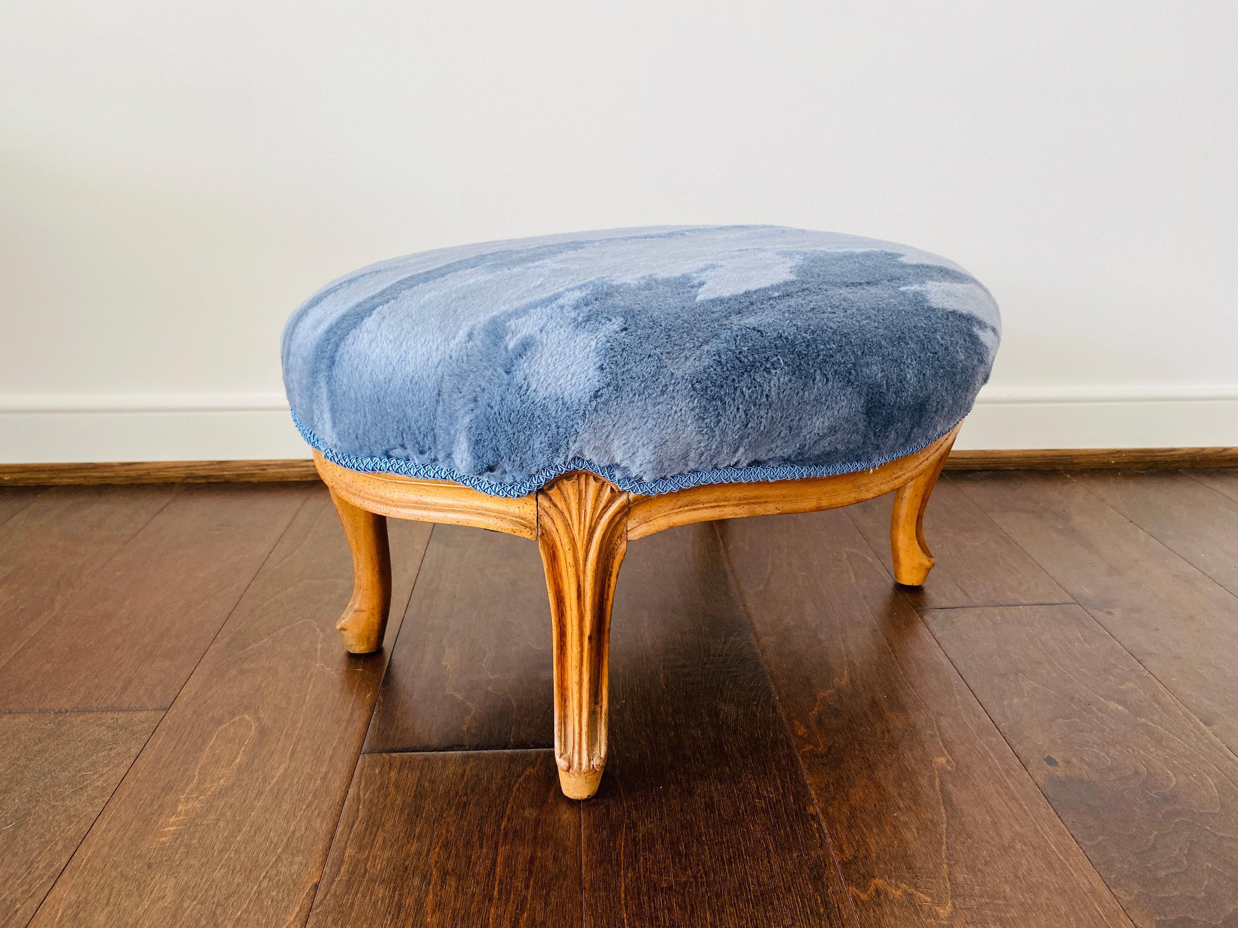 Listed is an absolutely stunning, 1950s French Provincial footstool. The piece has been newly reupholstered in Scalamandrés 'Polar Bear' mohair velvet in the 'Blue Frost' colorway from the 'Tundra Collection', imported from Italy. Tonal and textural