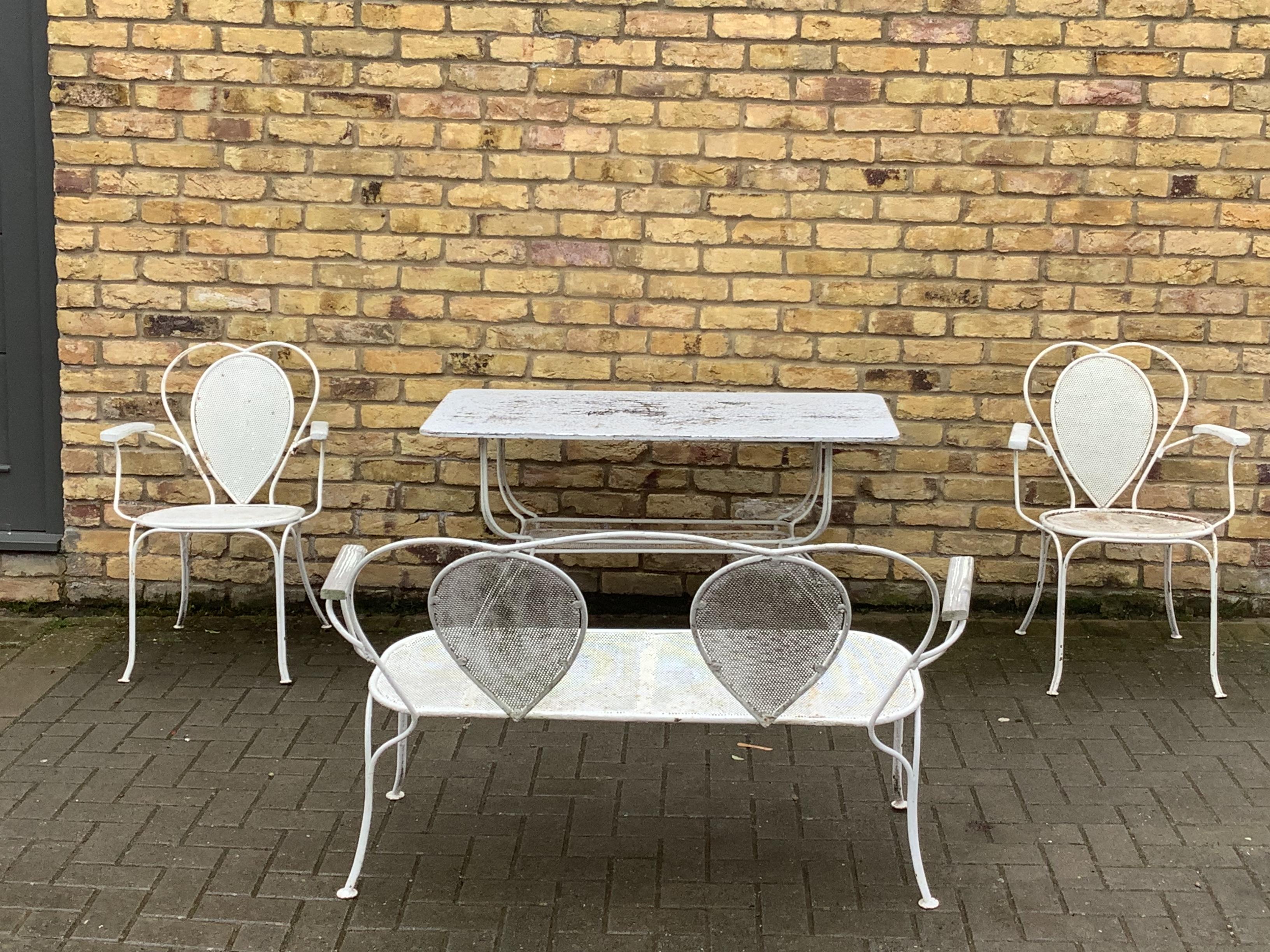 A collection of delightful French metal garden set.Two stackable chairs lovely two seater small bench also a 
Dining table.

Dimensions 
Two seater Bench 
124cm wide
83cm. High 
48cm. Deep

Table 
122cm wide
61cm. Deep
70cm. High.