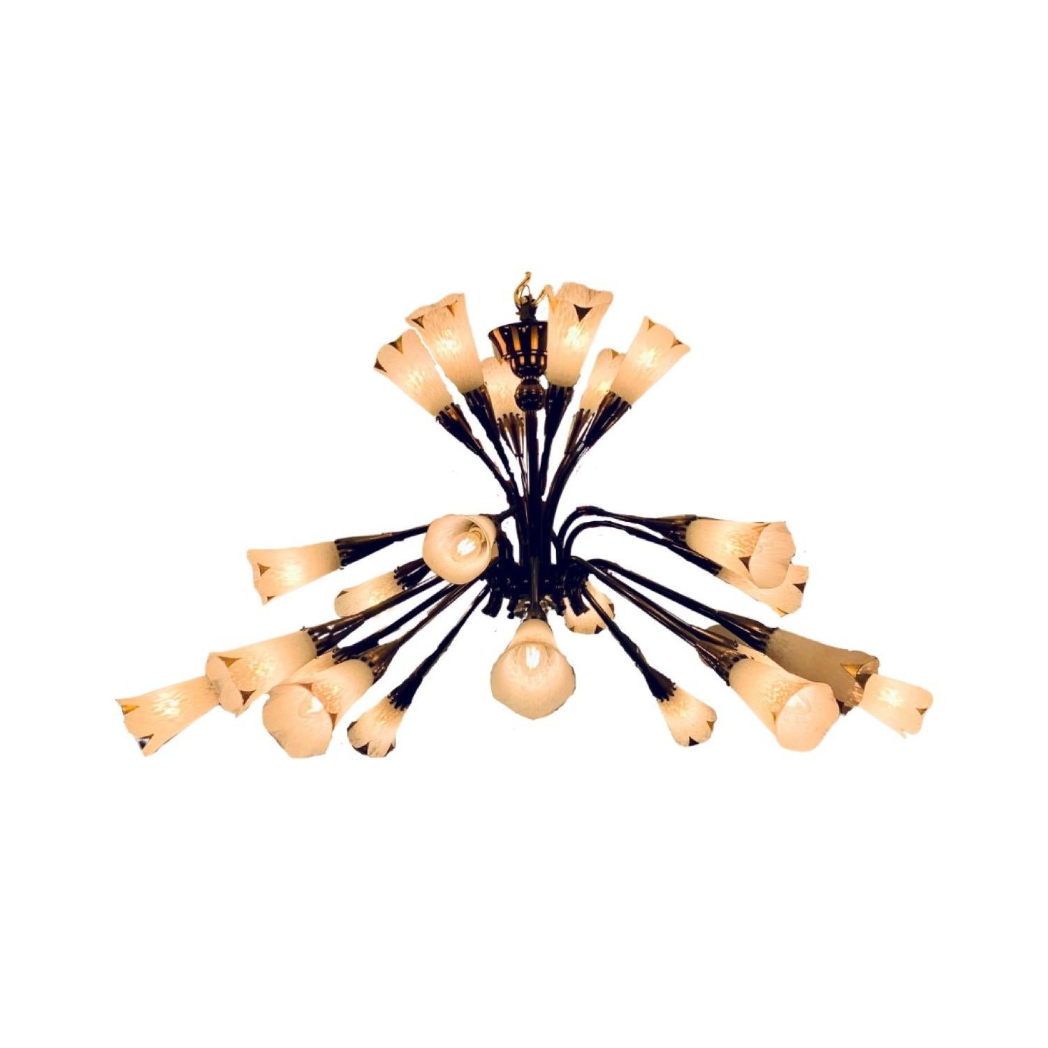 A large, 1950s, mid century, French chandelier by Gênet et Michon. The polished brass frame has a beautiful aged patina and is very well made. The 24 arms are in three-tiers - 6 positioned towards the ceiling, 6 below and 18 around the outside each
