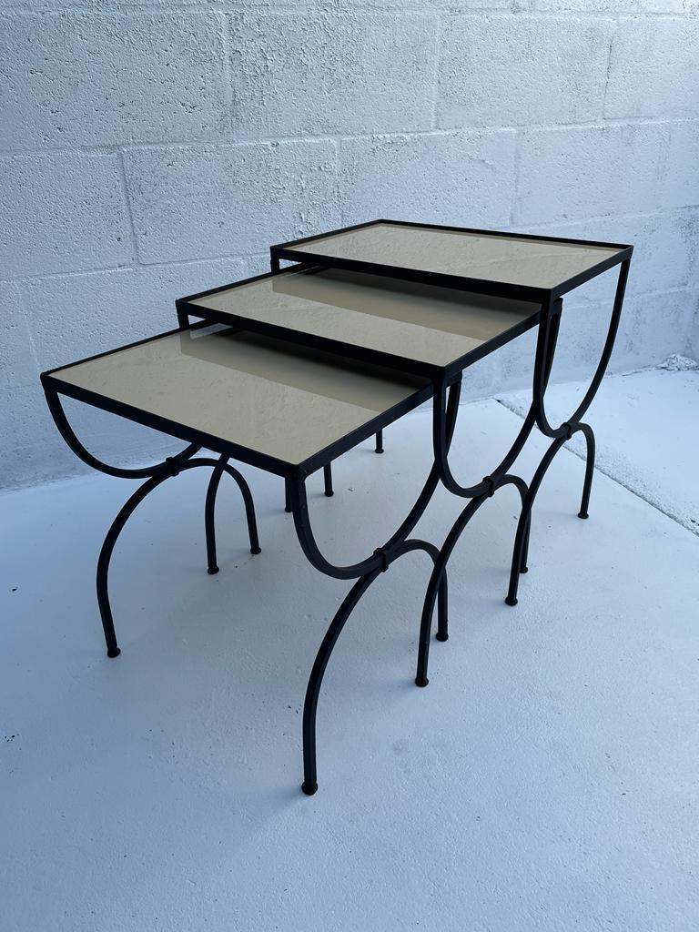 French mid-century 3 gigognes tables in the Jansen style, legs in arcades, resting on a double base in X.
The black metal is matt and patinated. The opaline glass tile is beige in a milky shade
Table 1 : Size 18x12 height 19 inches 
Table 2 :