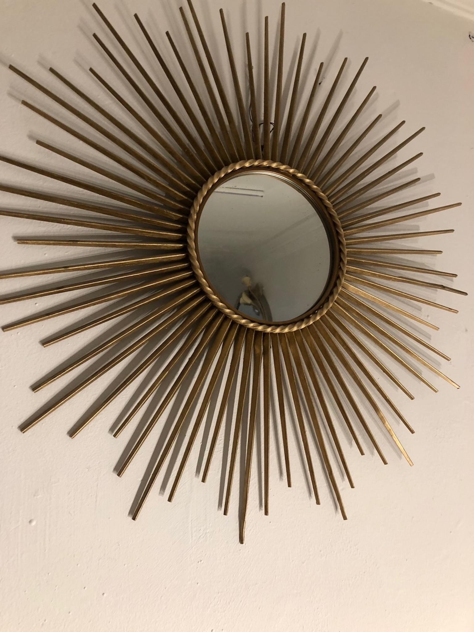 A 1950s French gilt metal sunburst (or starburst) brass mirror, the circular plate within a moulded frame with ropetwist trim, by Chaty Vallauris, stamped to back, d. 71 cm.