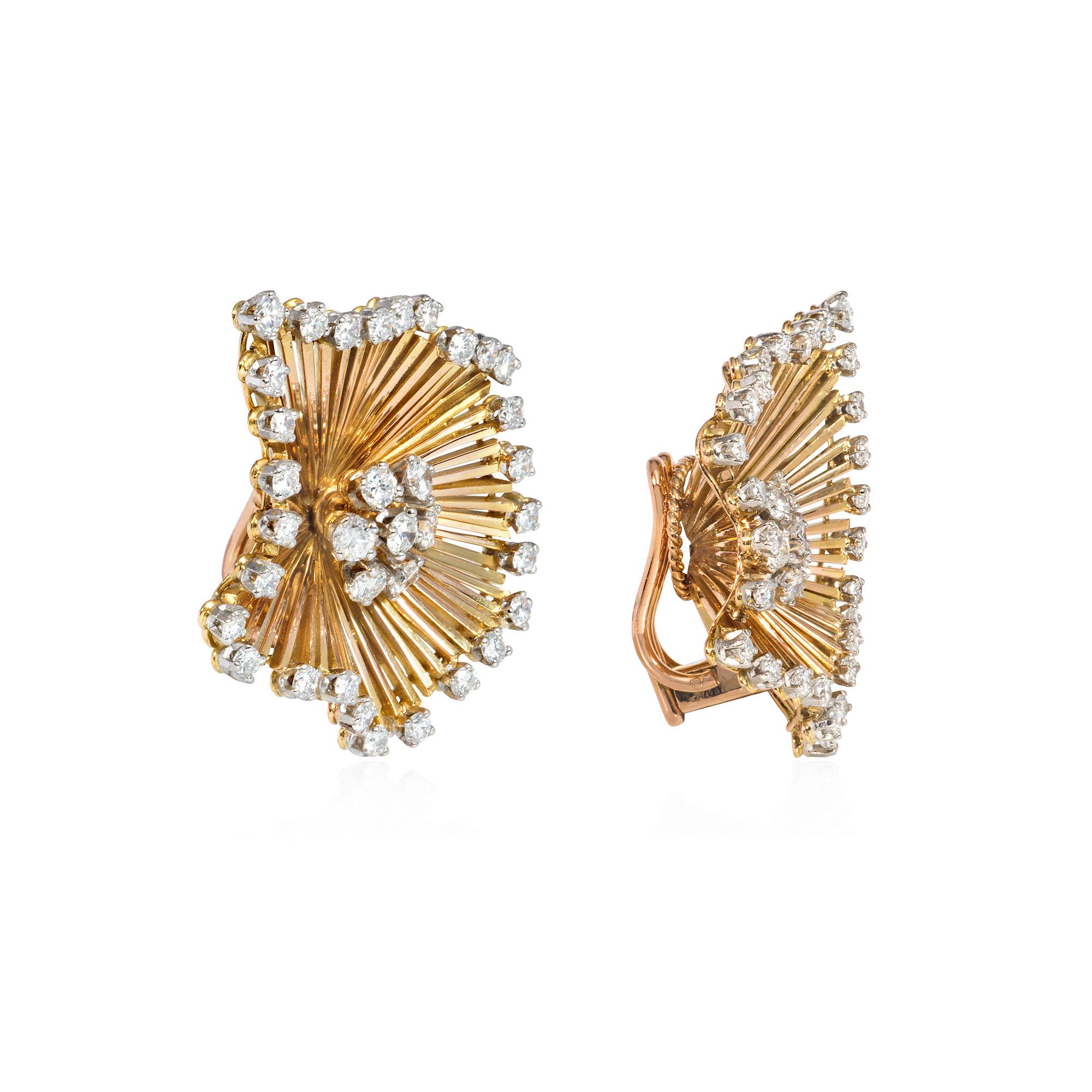 A pair of mid-century gold and diamond clip earrings of undulating burst design, with diamond cluster centers surrounded by finely graduated gold wire, terminating in a diamond border, in 18k. France. Atw 1.84 ct.