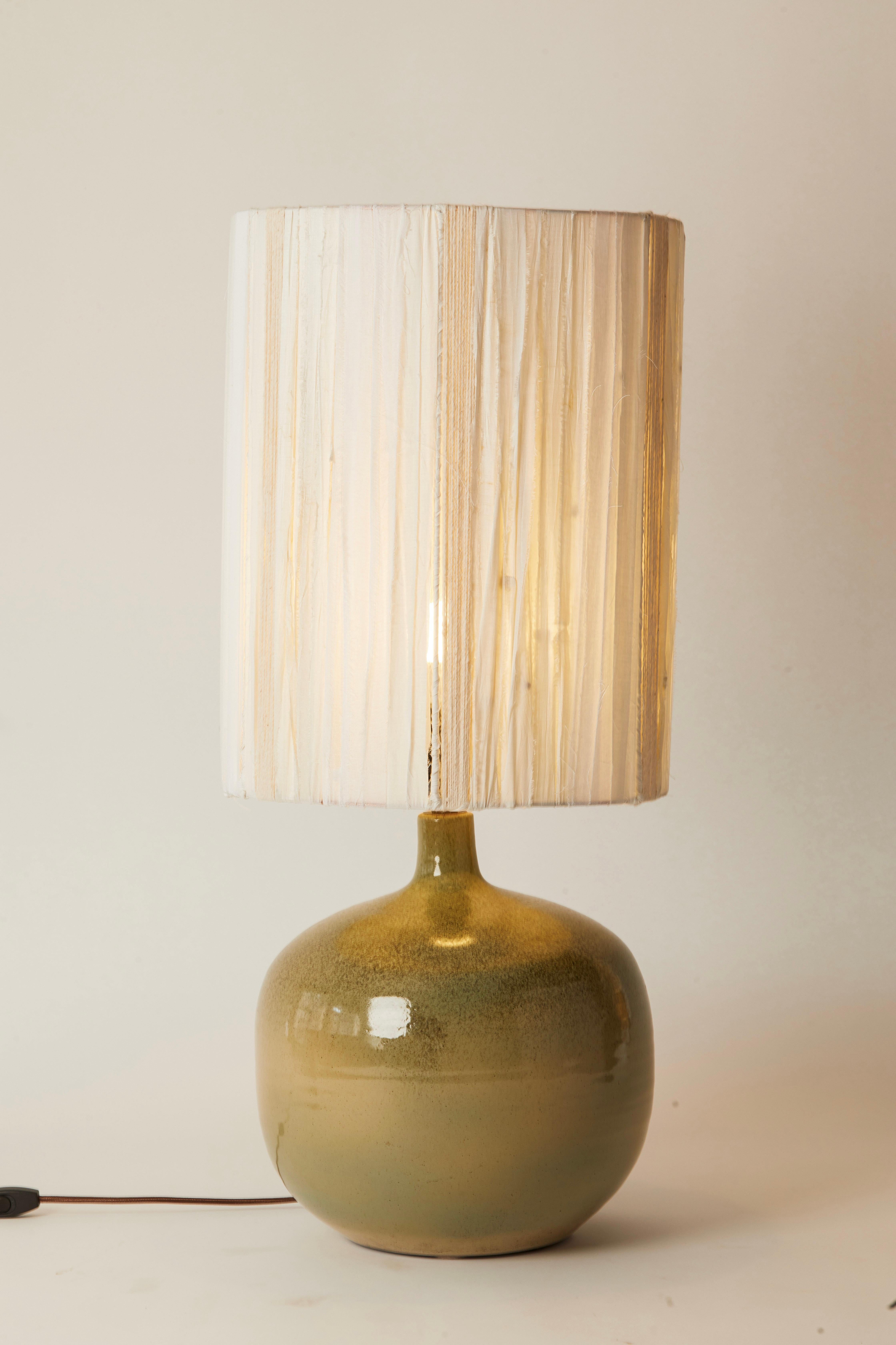 1950s French green speckled pottery lamp with coordinating ivory and brown rope shade. Strips of ivory fabric add dimension to the unique lampshade.