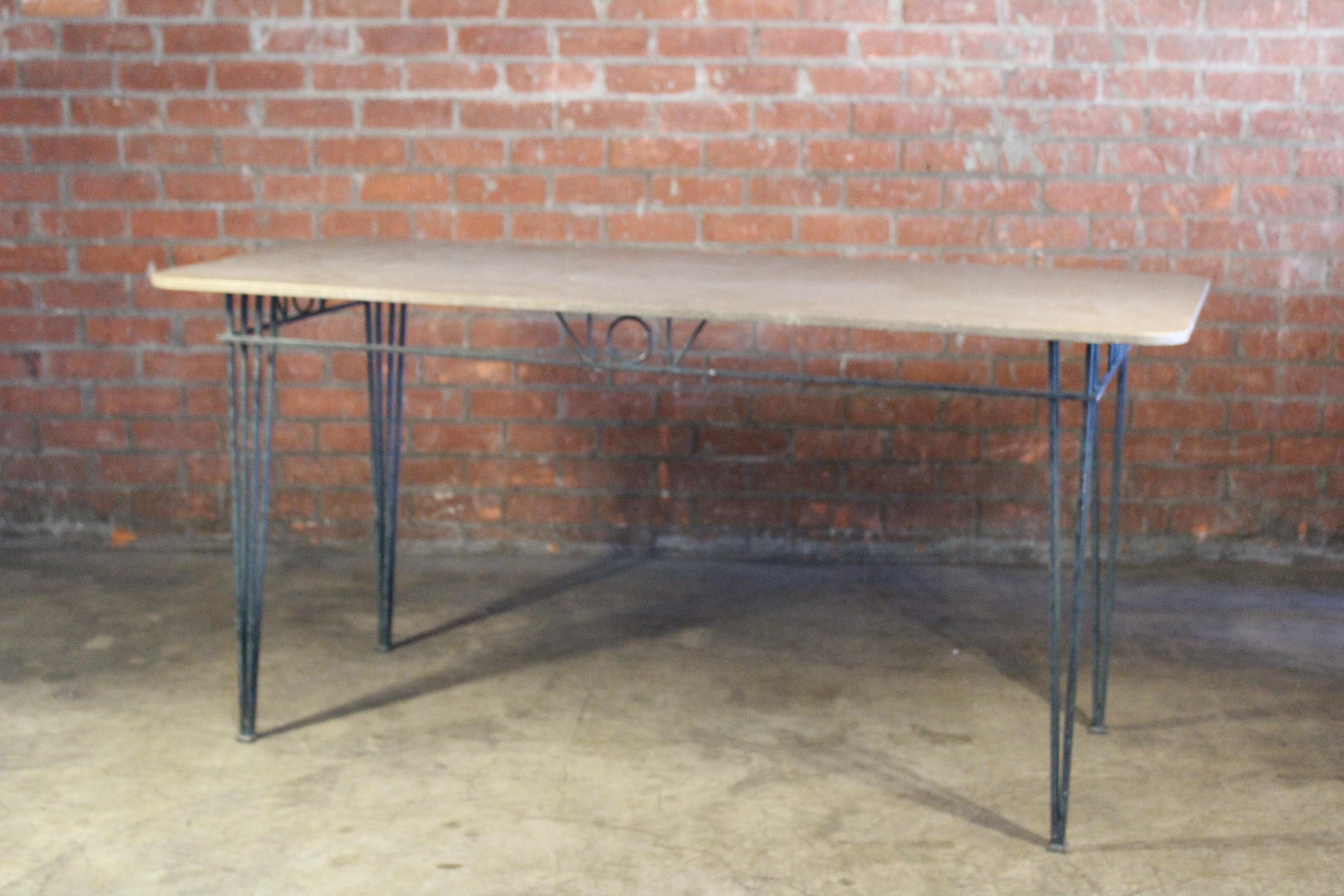 A vintage bar-height console or dining table from France, 1950s. Stone top. in good condition with patina to the iron base.