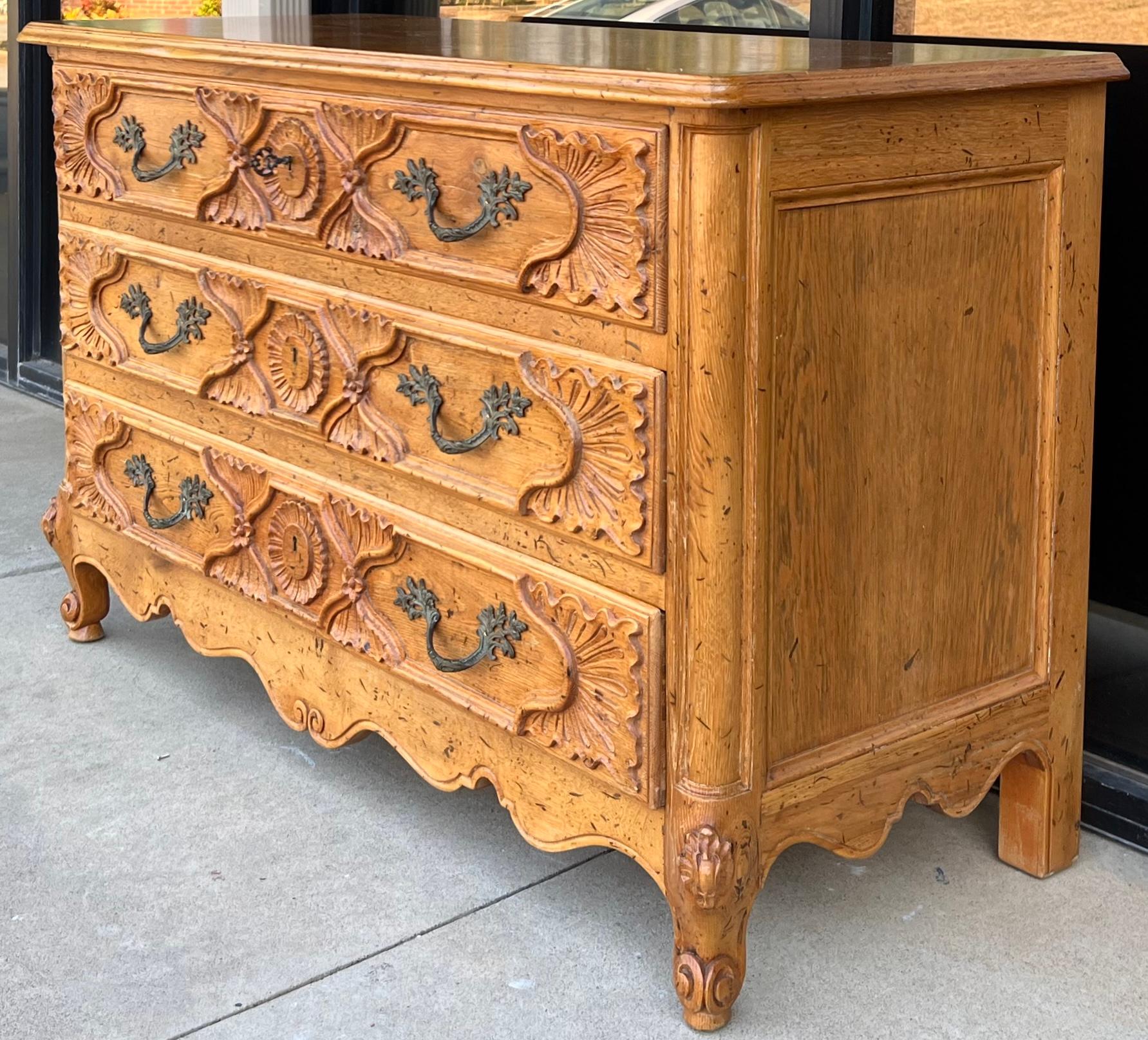 I love this! You don’t often see pine with such elaborate carving! It is a French pine three drawer chest with Louis XIV styling. The drawers are lined with paper. The only condition issue that I would like to note is that the top drawer has some