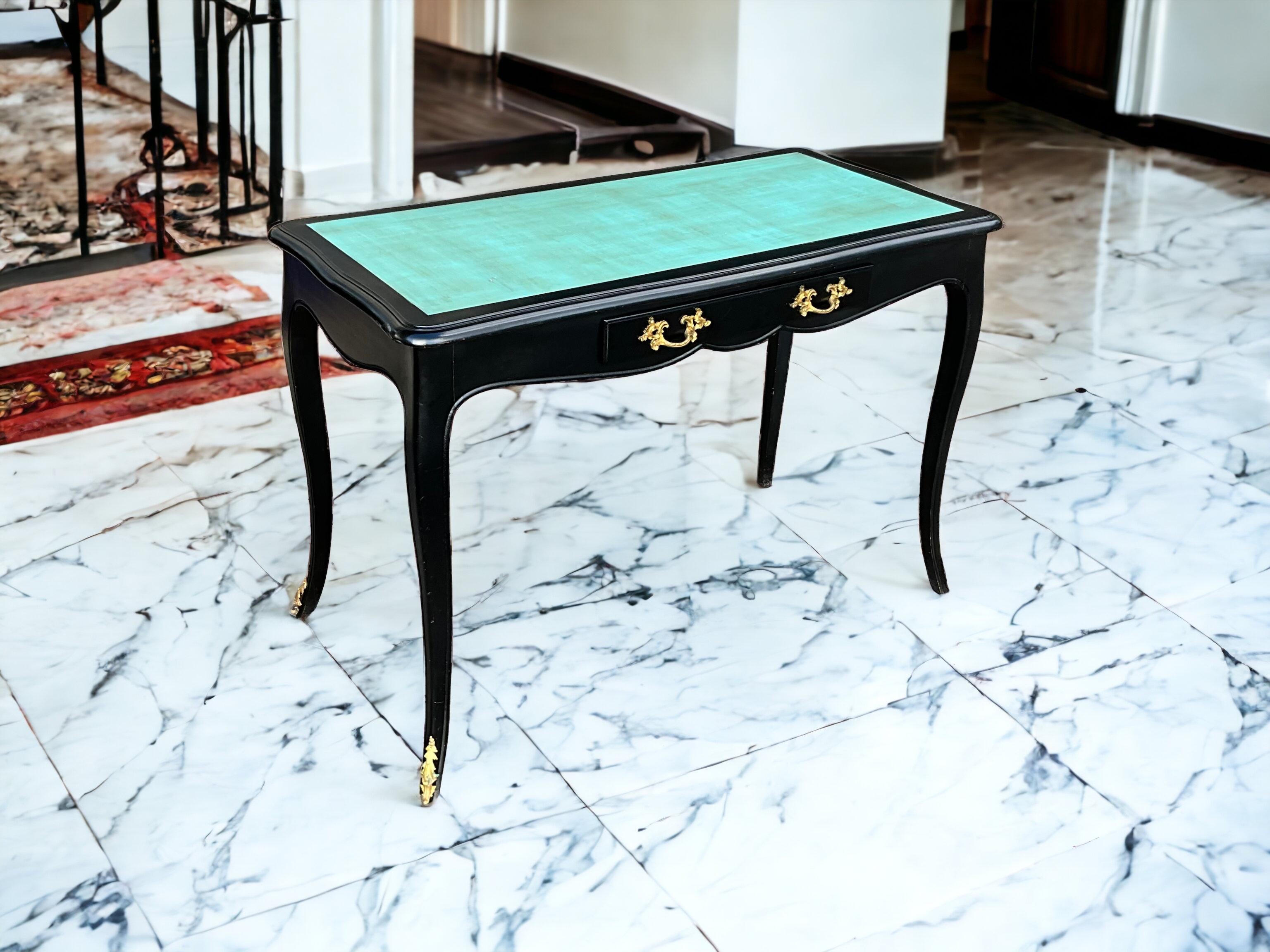 This is a French Louis XIV style desk that is in very good condition. The desk is marked. The antique hardware is gilt bronze and not original. The turquoise top has an antique glaze. 