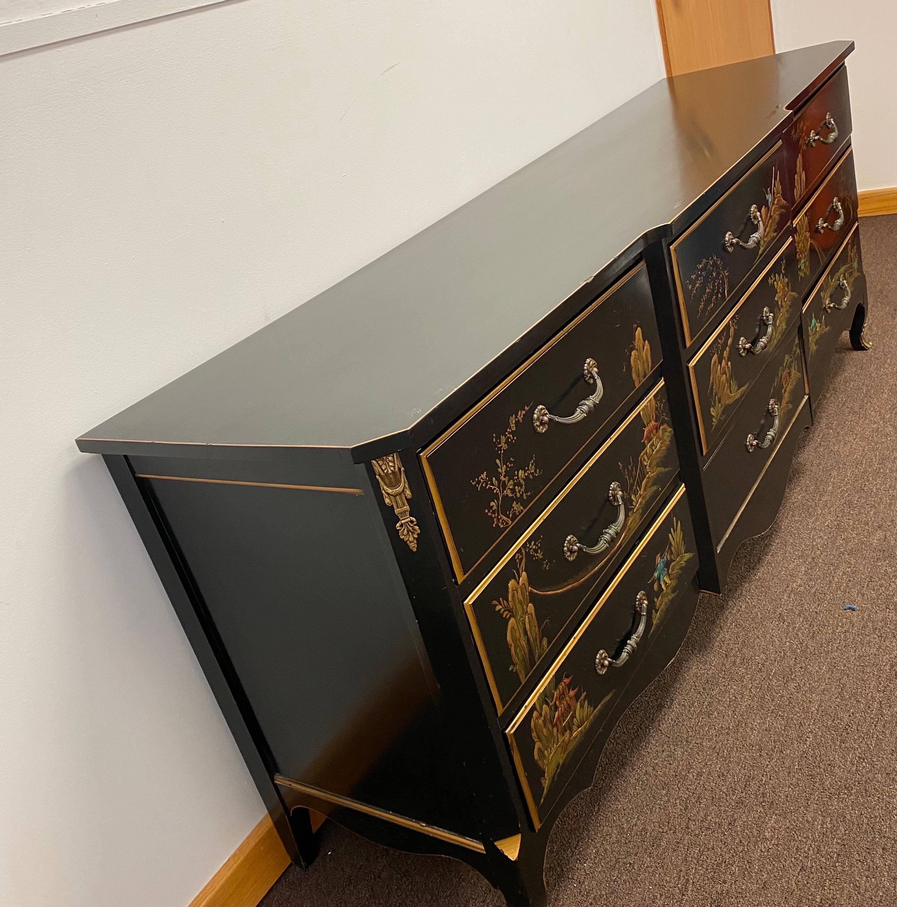 We are very pleased to offer a stunning Asian style dresser, circa the 1950s. Showcasing a French Louis XV Chinoiserie style, this piece is crafted from solid wood and finished in a rich black lacquer. Nine spacious drawers tuck away clothes and