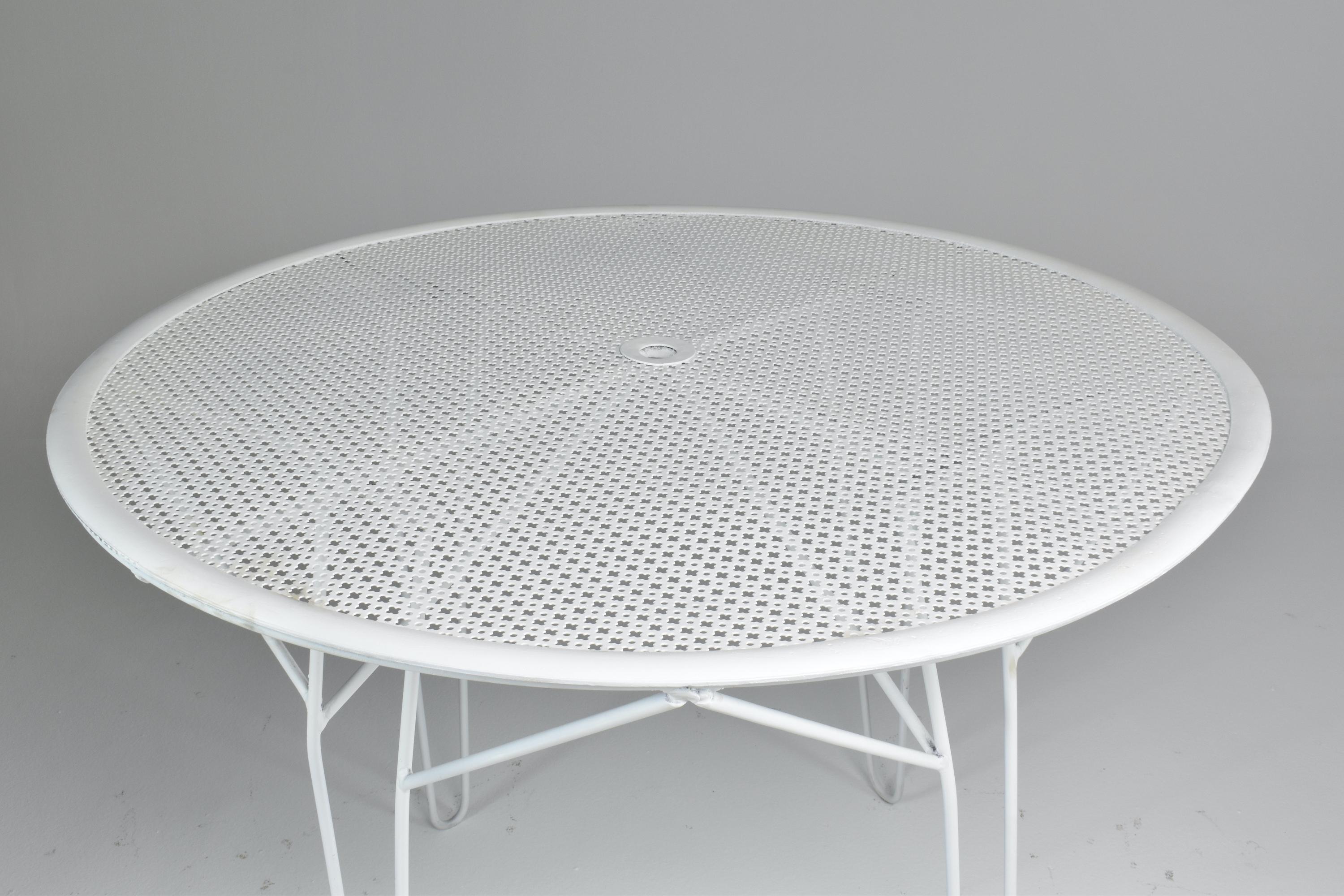 A beautiful circular garden table by the iconic French mid-century designer Mathieu Mategot. This collectible piece is made of his signature perforated sheet and white tubular lacquered steel. 
France. Circa 1950's. 

-----
We are an exhibition