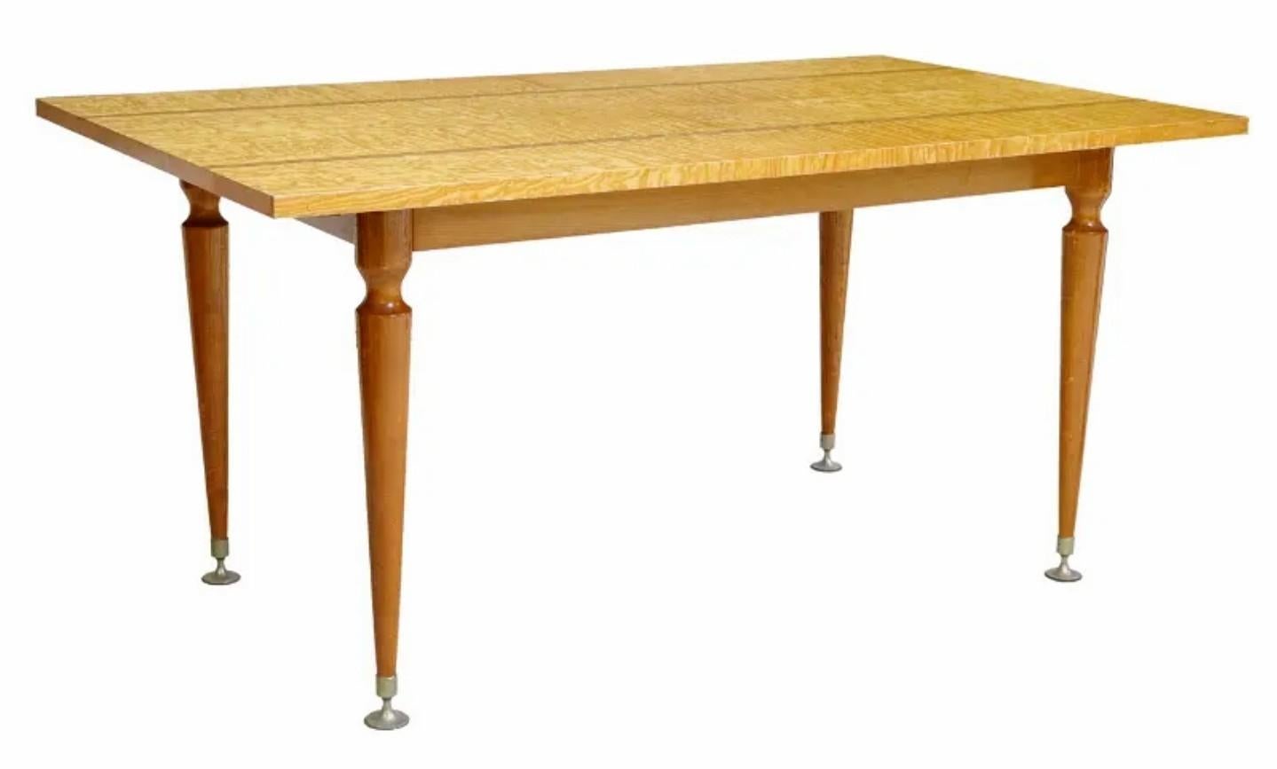 A fabulous designer French Mid-Century Modern dining table by NF Ameublement.

handcrafted in France, circa 1950s, exceptionally executed Scandinavian modernist taste, having a highly figured curly quilted sycamore maple top, with contrasting