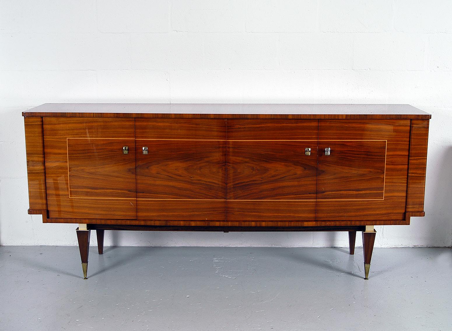 Elegant sideboard typical of pieces coming from high end workshops in France during the 1950s and 1960s. The design is rooted in the pre-war Art Deco style but obviously influenced by the pared down designs coming from Scandinavia in the 1950s. The