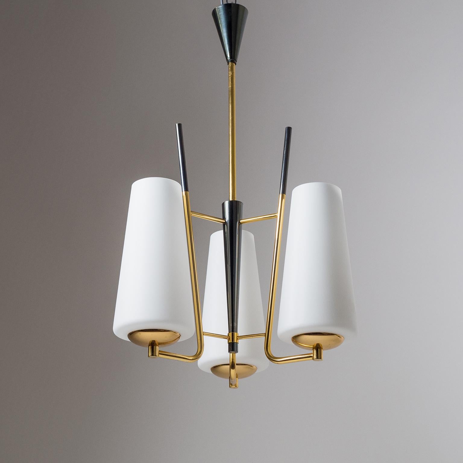 Very fine French modernist chandelier from the 1950s. Gilt brass hardware partially patinated in a dark 'gun-metal' color with three large (9.5inches/25cm) satin glass diffusers. Very good original condition with just minor patina on the metal