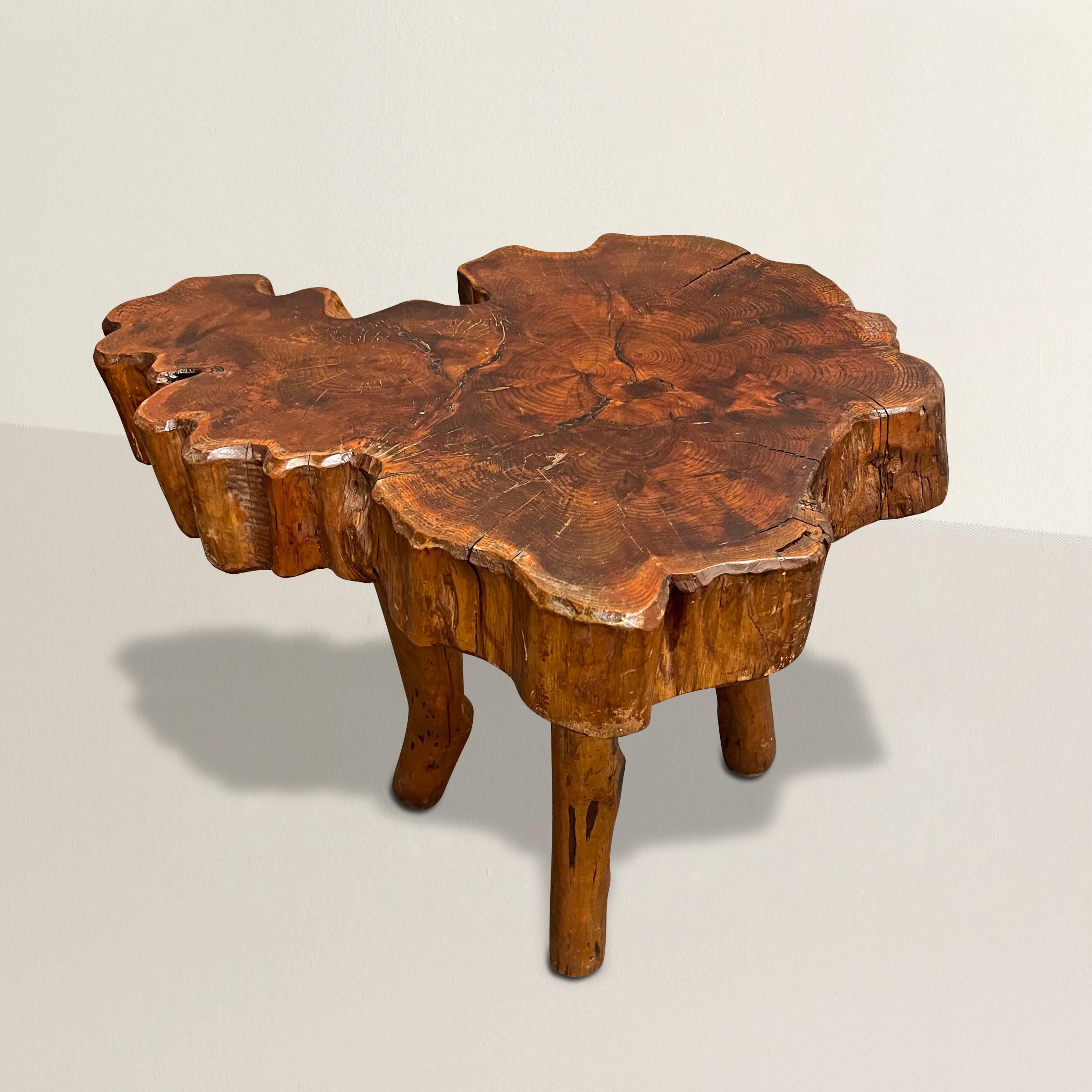 Immerse yourself in the harmonious blend of nature and modern design with this captivating French modernist live-edge table. Crafted from a remarkable slab section of burl wood, the table showcases the exquisite beauty of the natural world. Its live