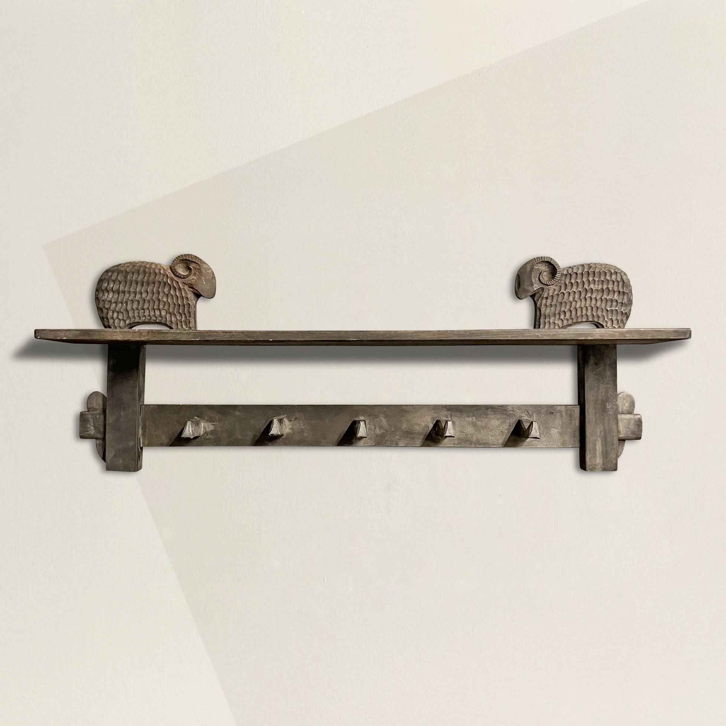Add a touch of mid-century French modernist charm to your space with this exceptional 1950s wall shelf and coat rack. Crafted with an eye for both functionality and artistic design, this shelf features five convenient coat or hat hooks and two